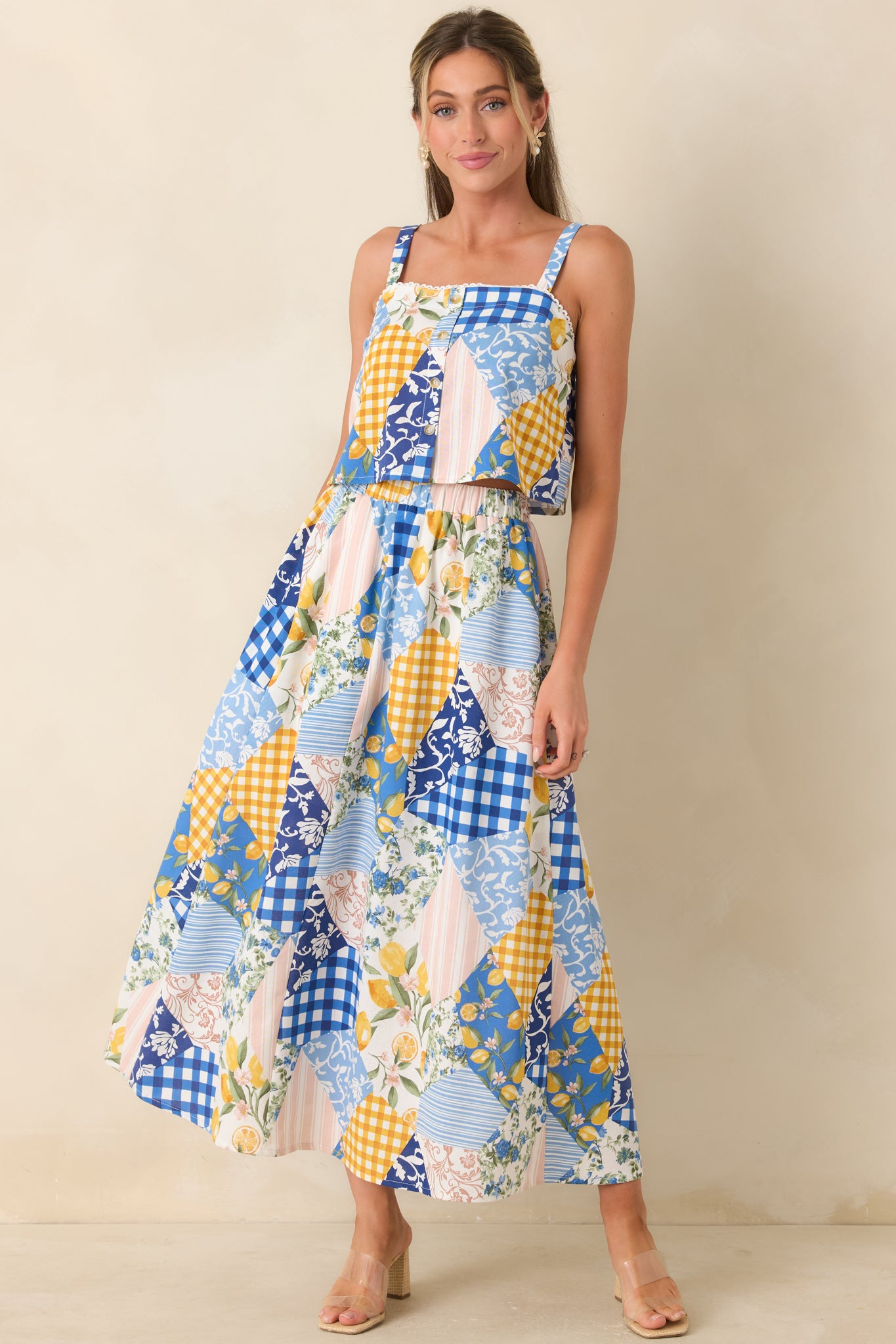 Blue multi cropped top featuring patchwork print, square neckline, and button front design with an easy, lightweight fit.