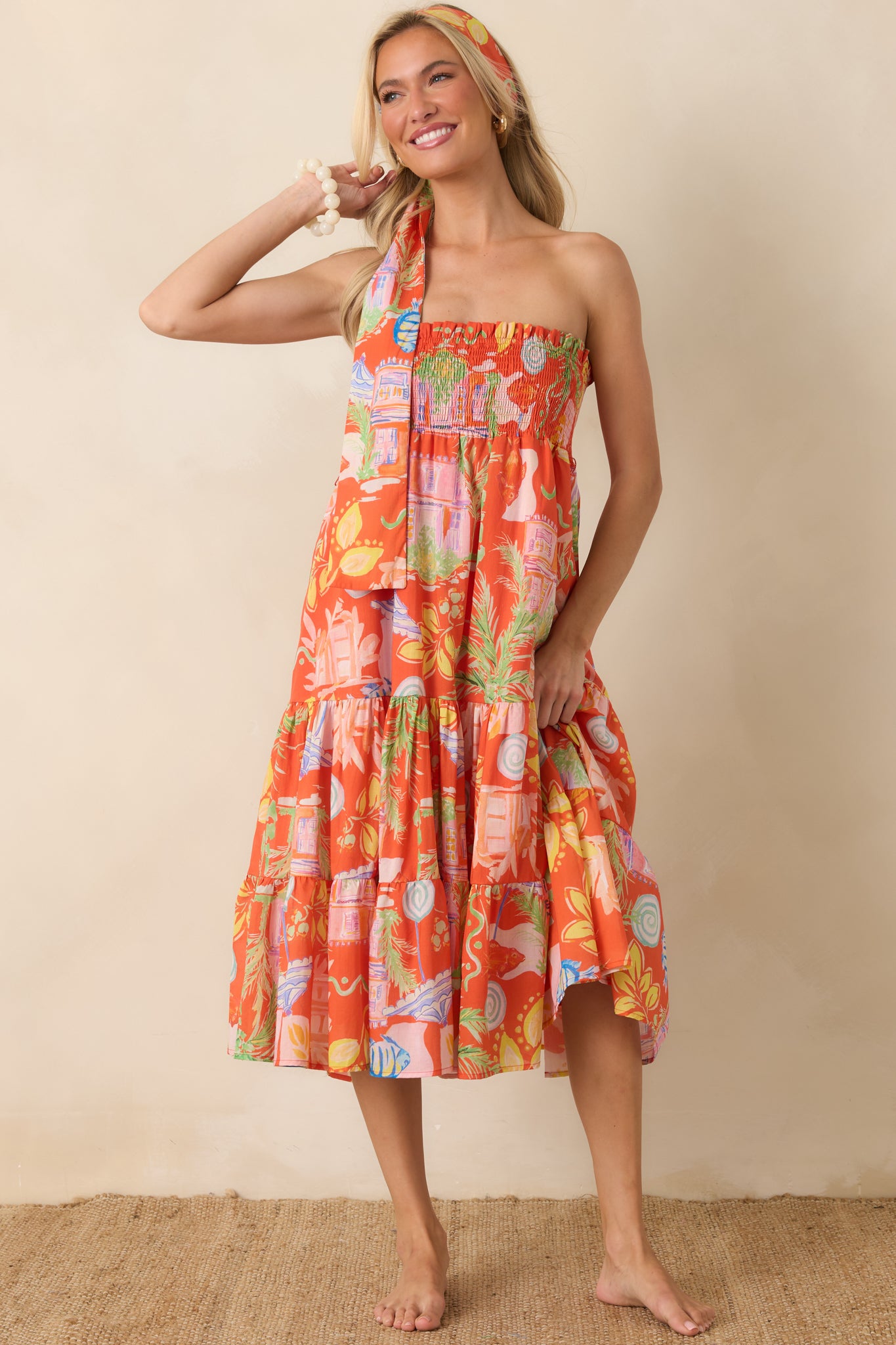Orange printed multiway dress featuring a comfortable stretch bodice and soft tiered layers designed for relaxed styling.