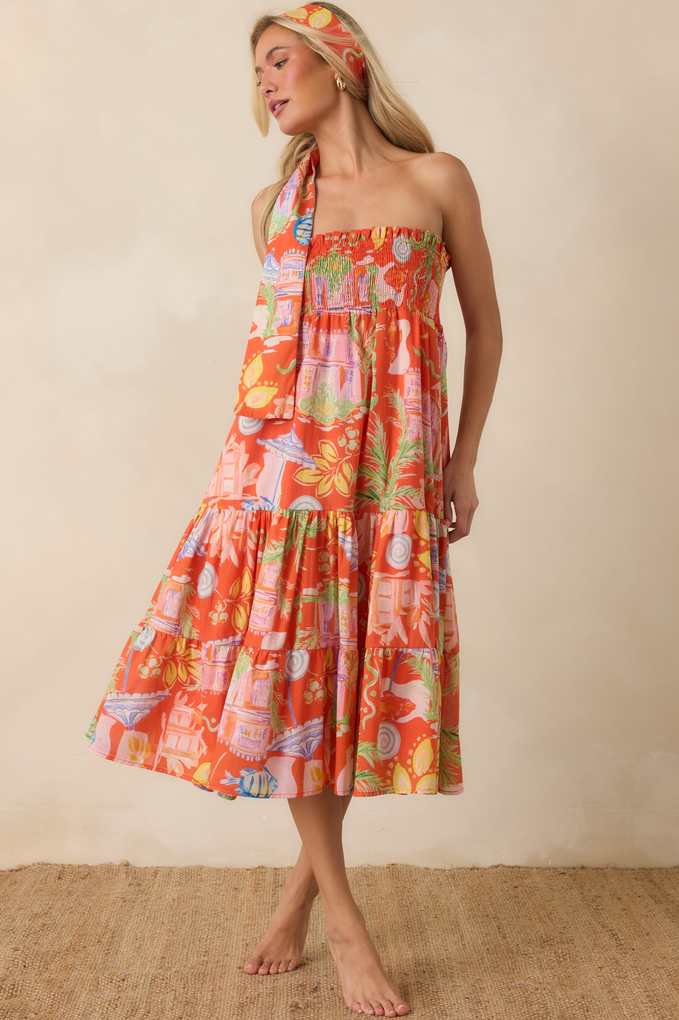 Multi-print cotton dress featuring a flexible strapless design, tiered construction, and an easy vacation-ready silhouette.