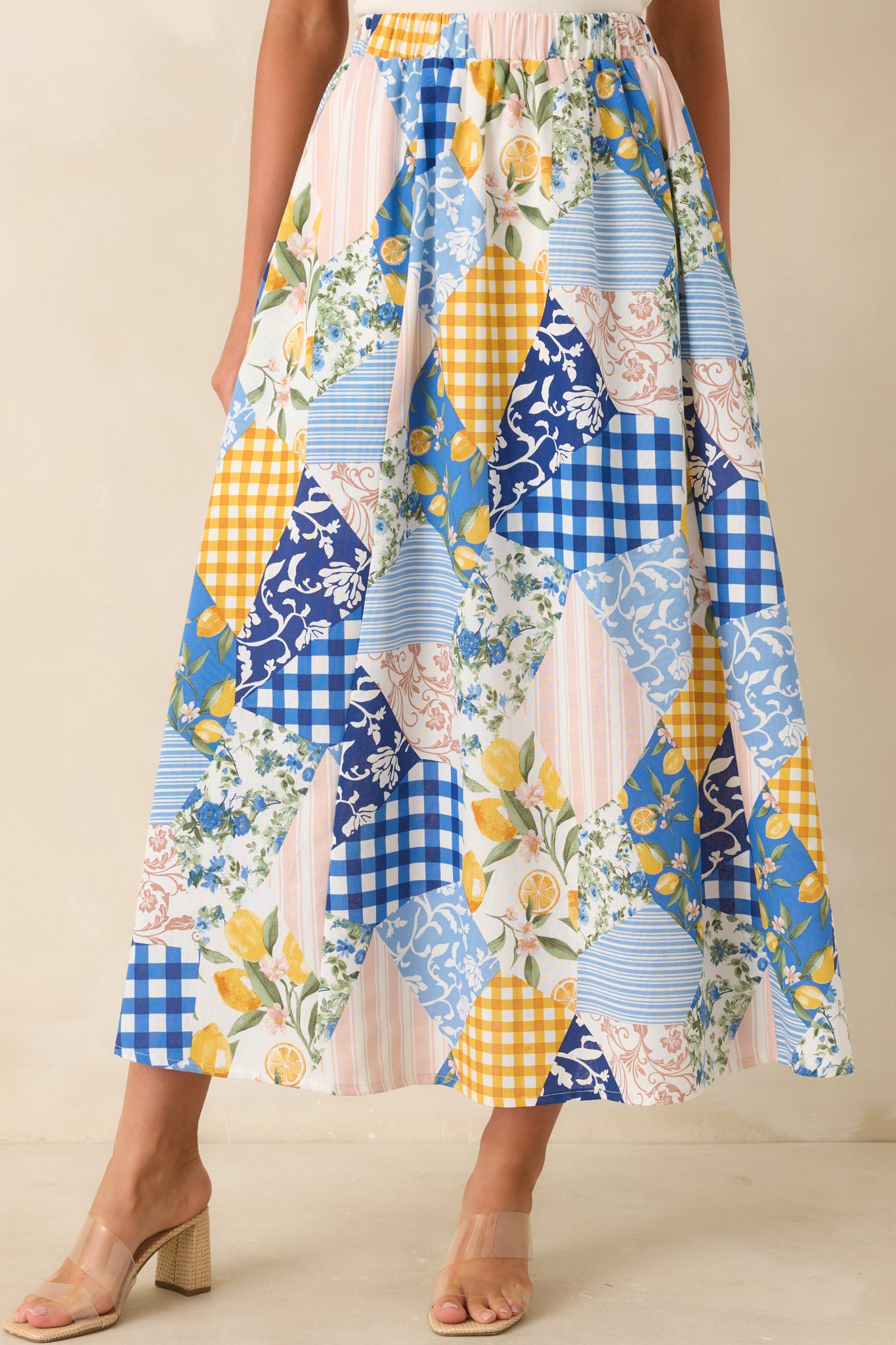 Elastic waistband detail on patchwork midi skirt with gathered, flexible fit.