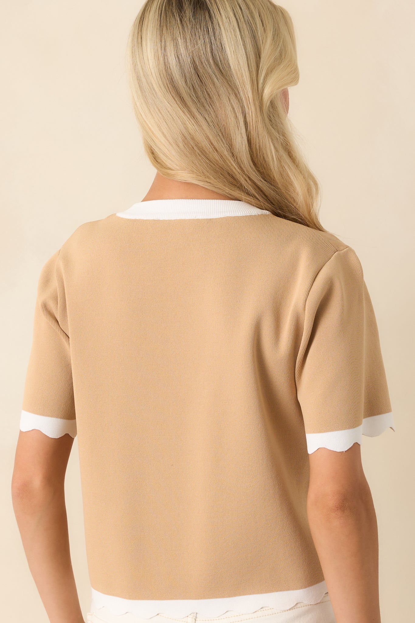 The back of the top maintains a clean and minimal look, with the relaxed fit complementing its effortless style.