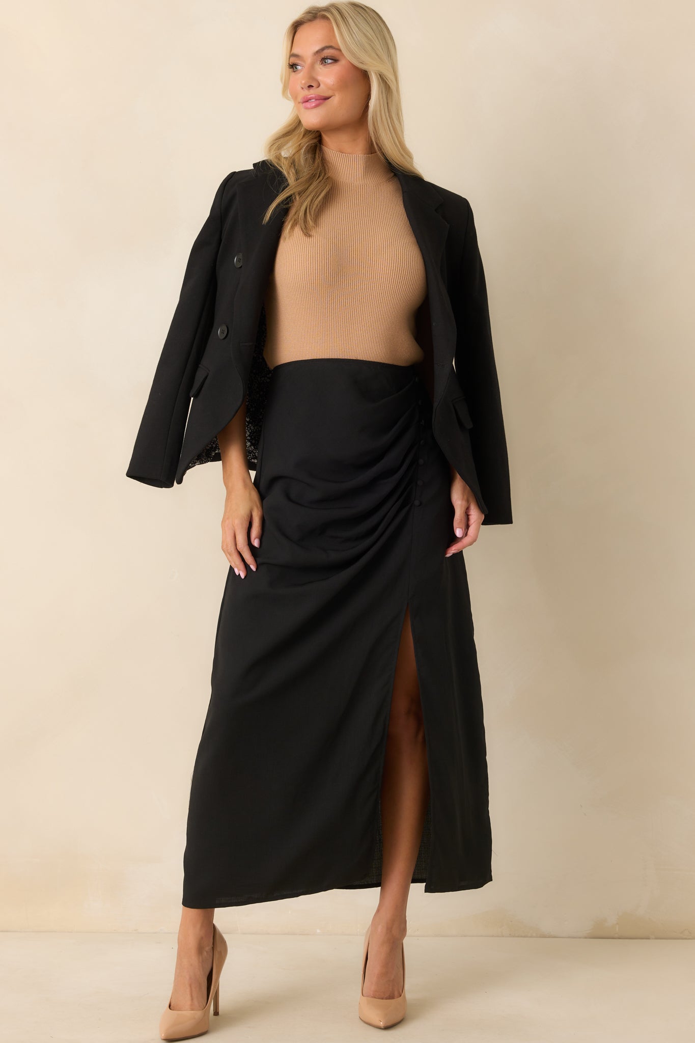 Full body view of the black blazer featuring a collared V-neckline and structured silhouette.