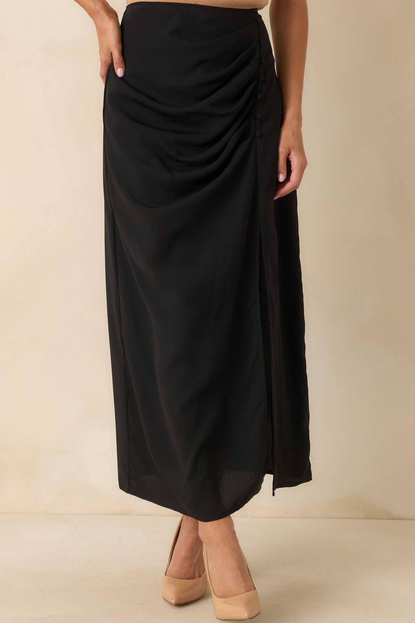 A cropped image of the lower skirt showing the side slit and flow of the fabric around the knee area.