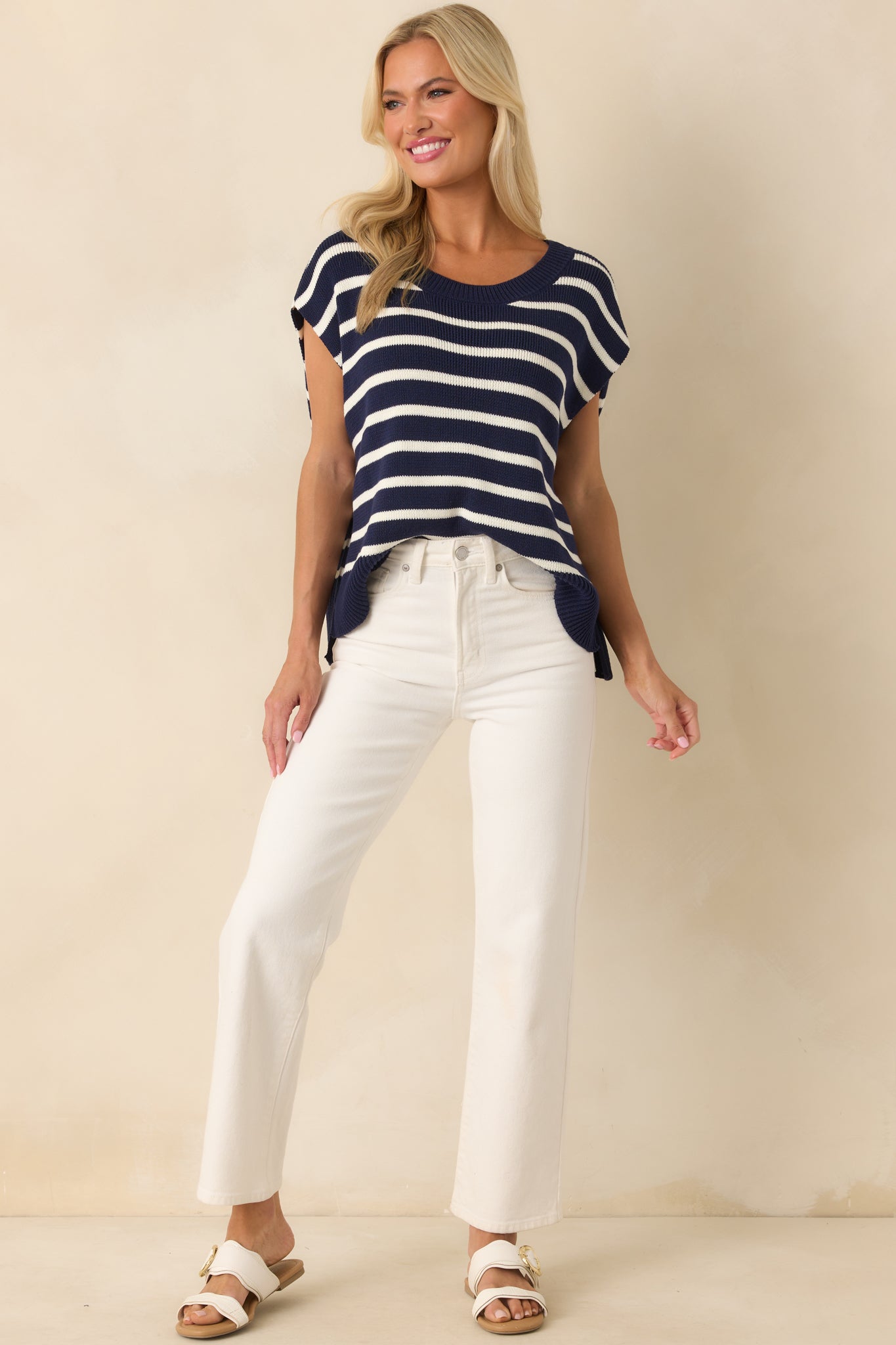 Front-facing full body image capturing the full length of the vest and the clean contrast between the navy knit and white stripe pattern.