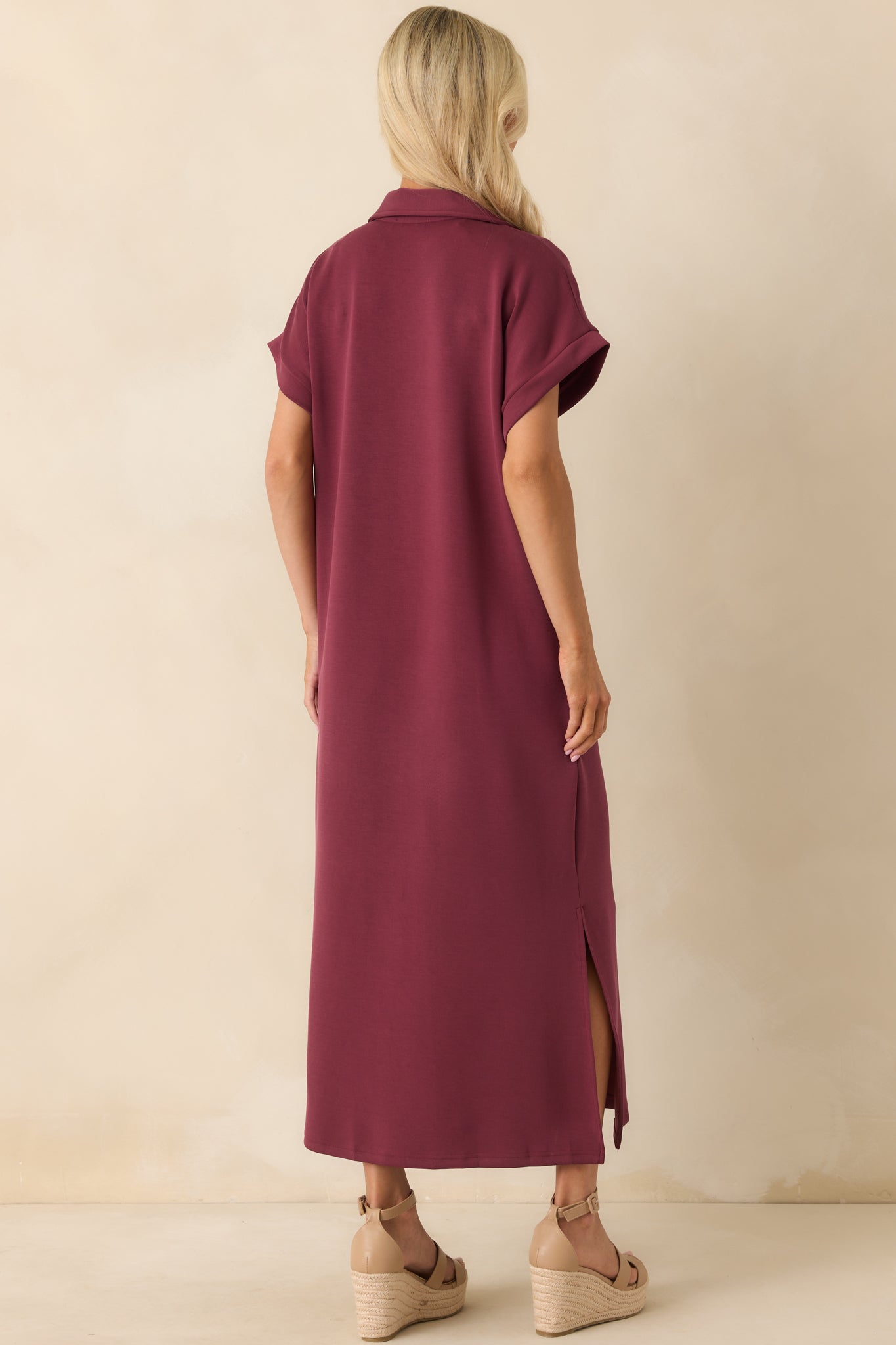 Back view of burgundy midi dress with short sleeves and straight hemline.