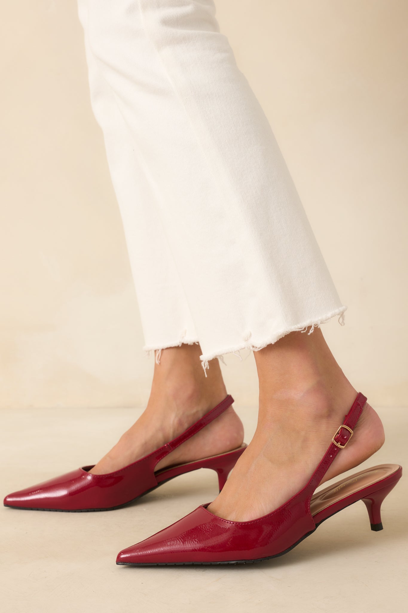 Close view of the adjustable slingback strap and smooth shiny surface.