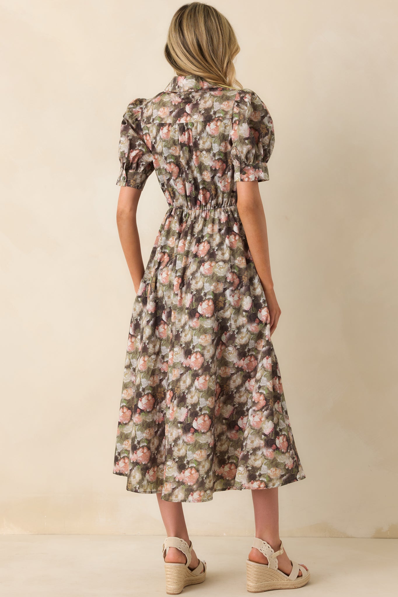 Back view of the dress showing the elastic waist insert and the continuation of the floral pattern.