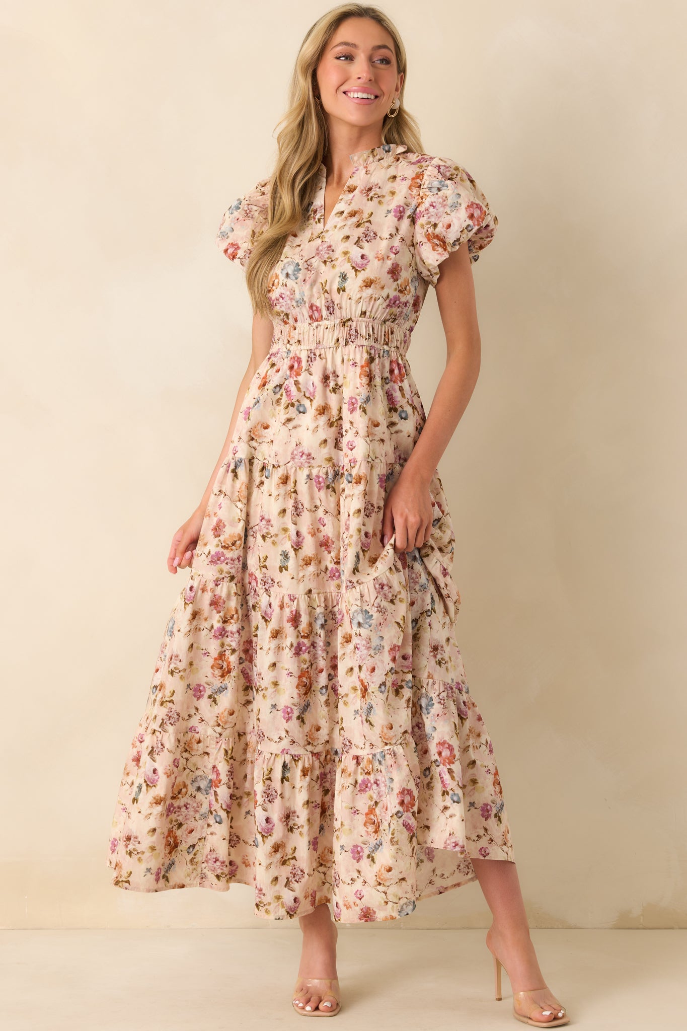 A full body image capturing the structure of the dress with a clear view of the floral print and tiered silhouette.