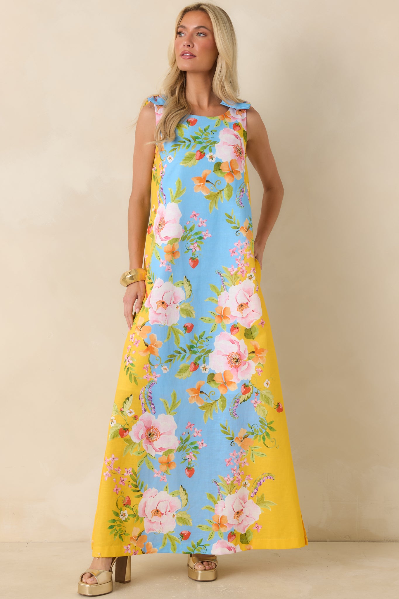 Relaxed-fit floral maxi dress with bow-tie straps, a fully lined construction, and a flowing hemline.