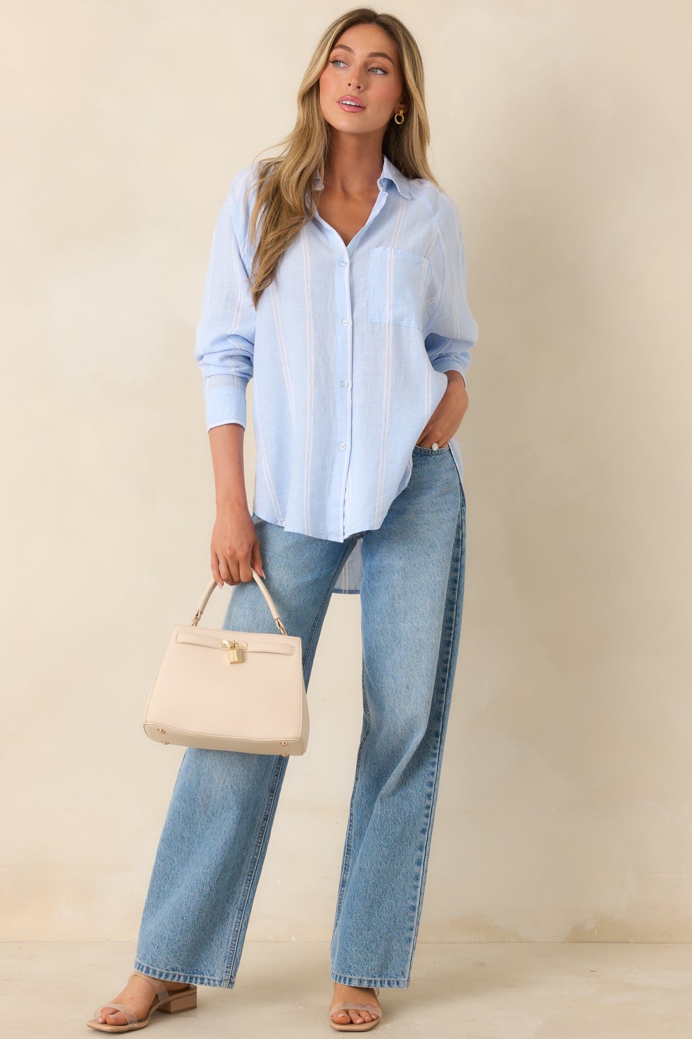 Lightweight linen blend button-up top with soft blue and ivory vertical stripes and collared neckline.