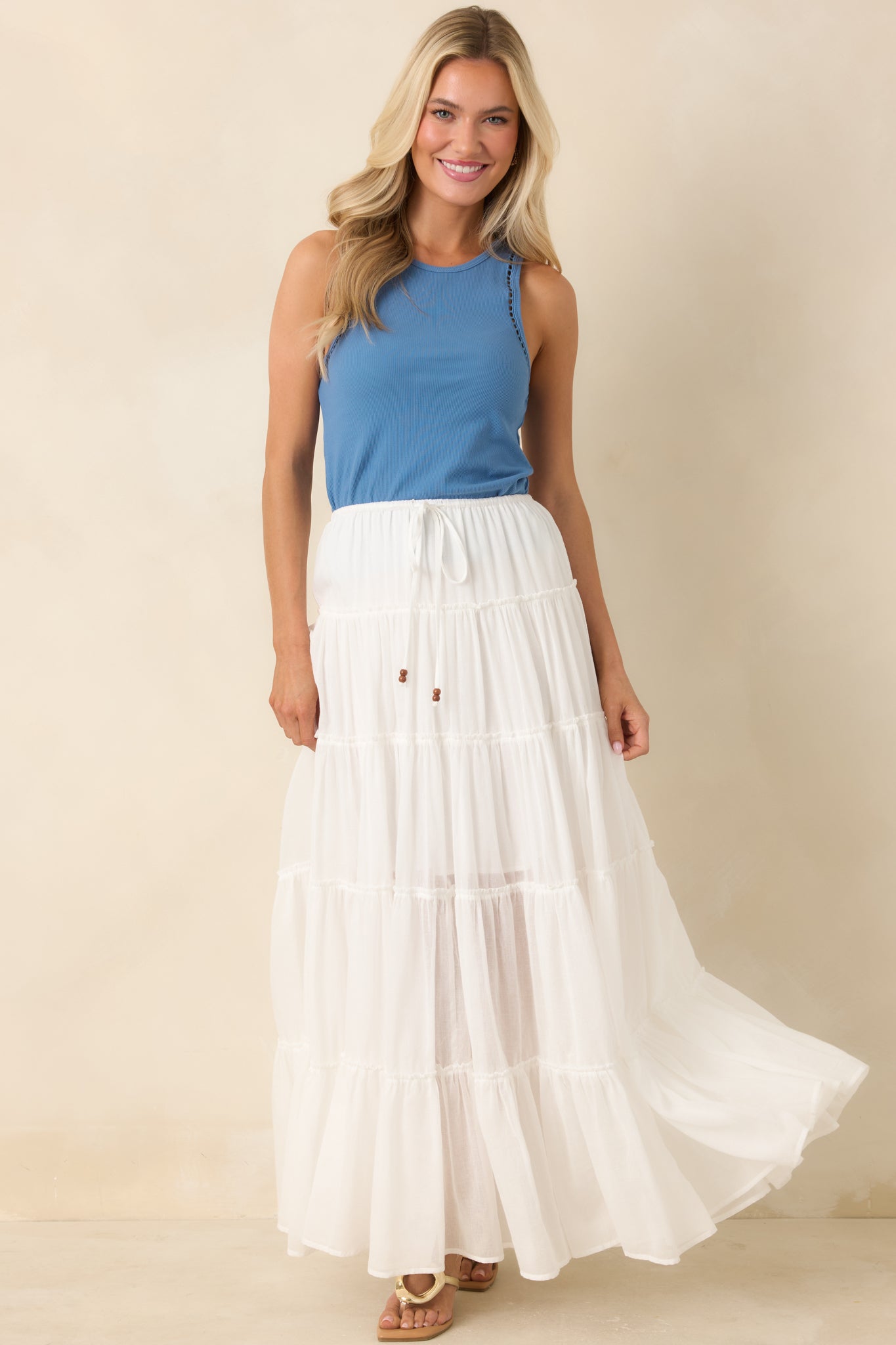 Soft rib knit top featuring subtle ladder trim along arm openings.