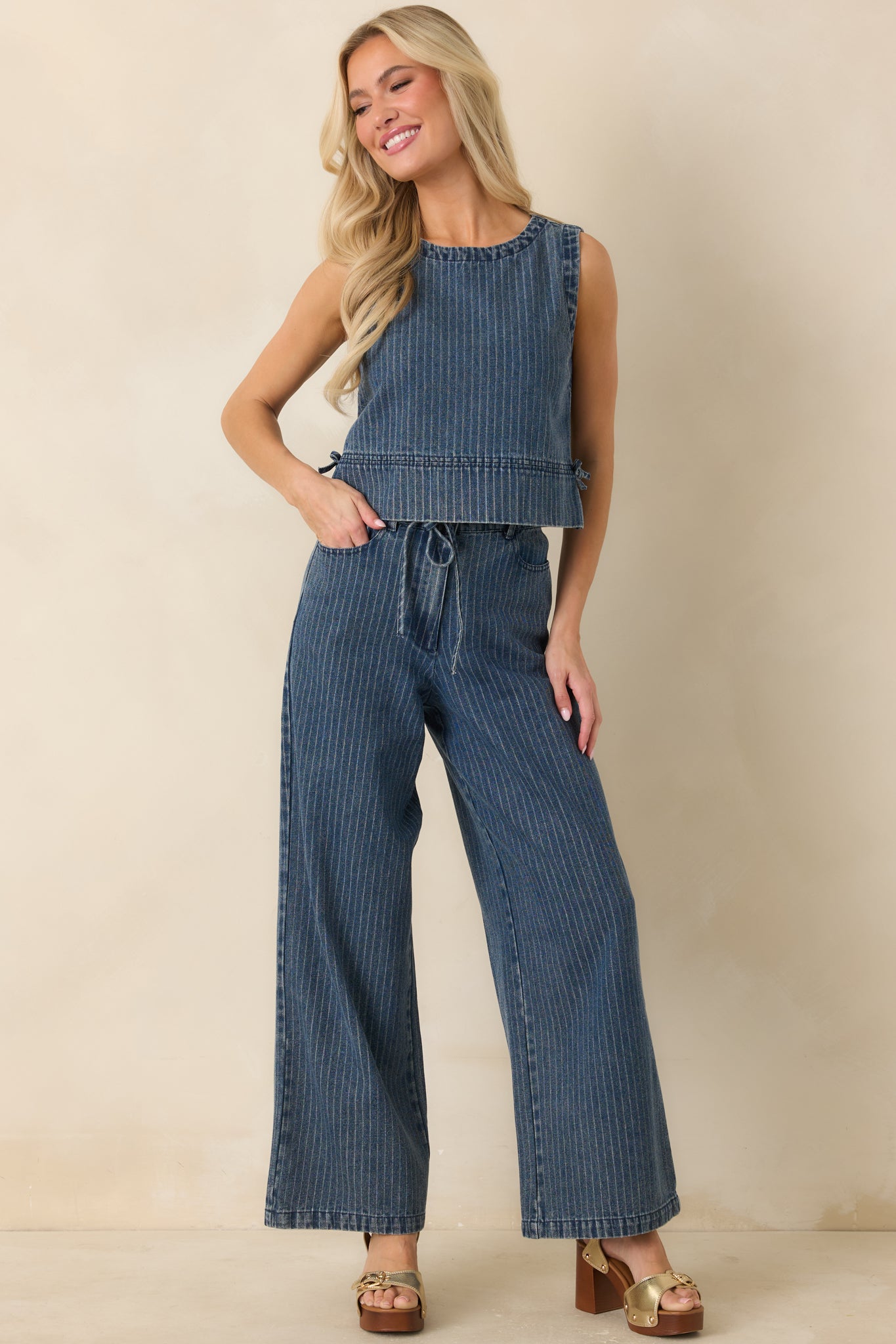 Front full view highlighting the cropped length, structured yet relaxed silhouette, and side tie accents along the waist.