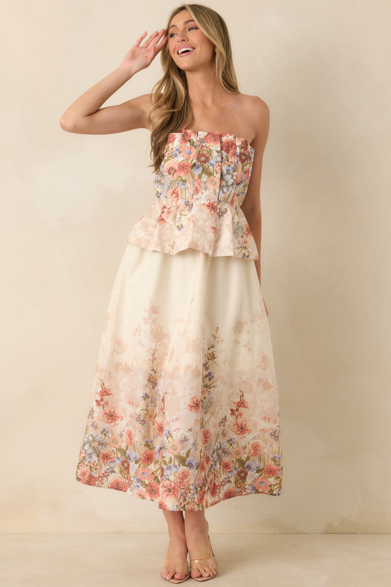 Floral pink midi dress with smocked back and flowing silhouette with side pocket detail.