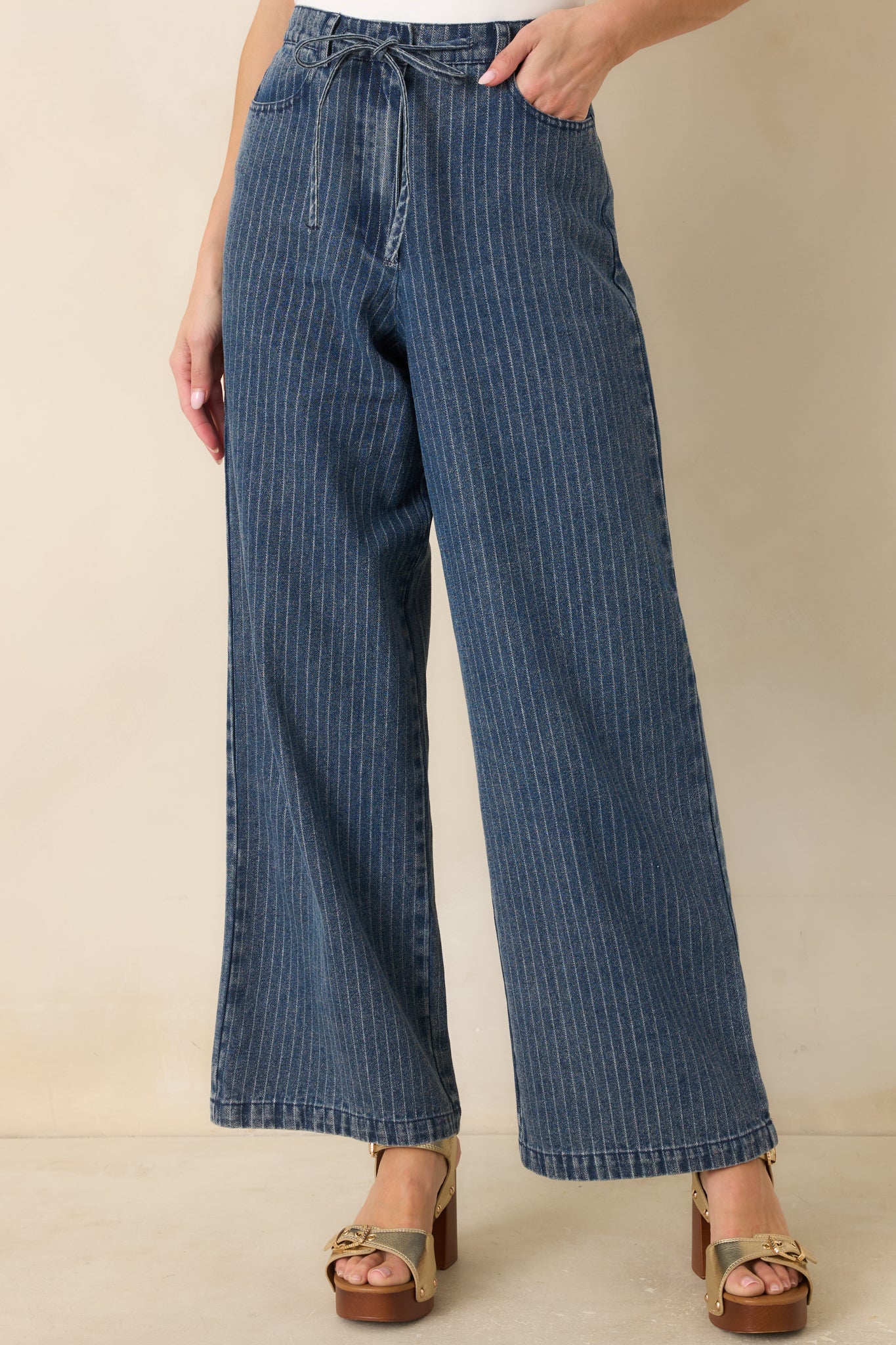 Close-up of the indigo stripe fabric showing the soft denim texture, subtle weave, and stitching along the seams.
