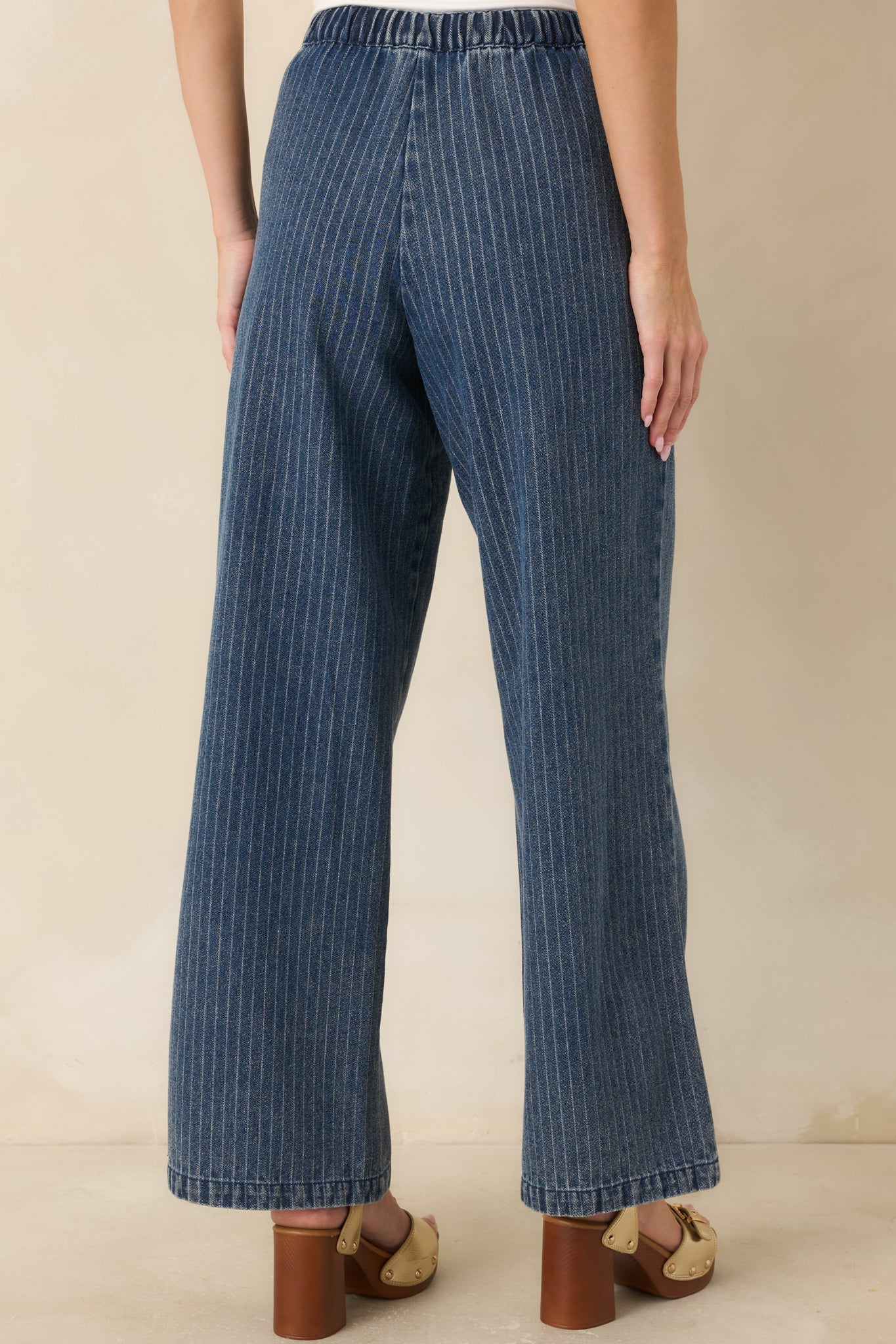 Rear view of the wide leg pants highlighting the elastic waistband, continuous stripe alignment, and relaxed full-length silhouette from behind.

