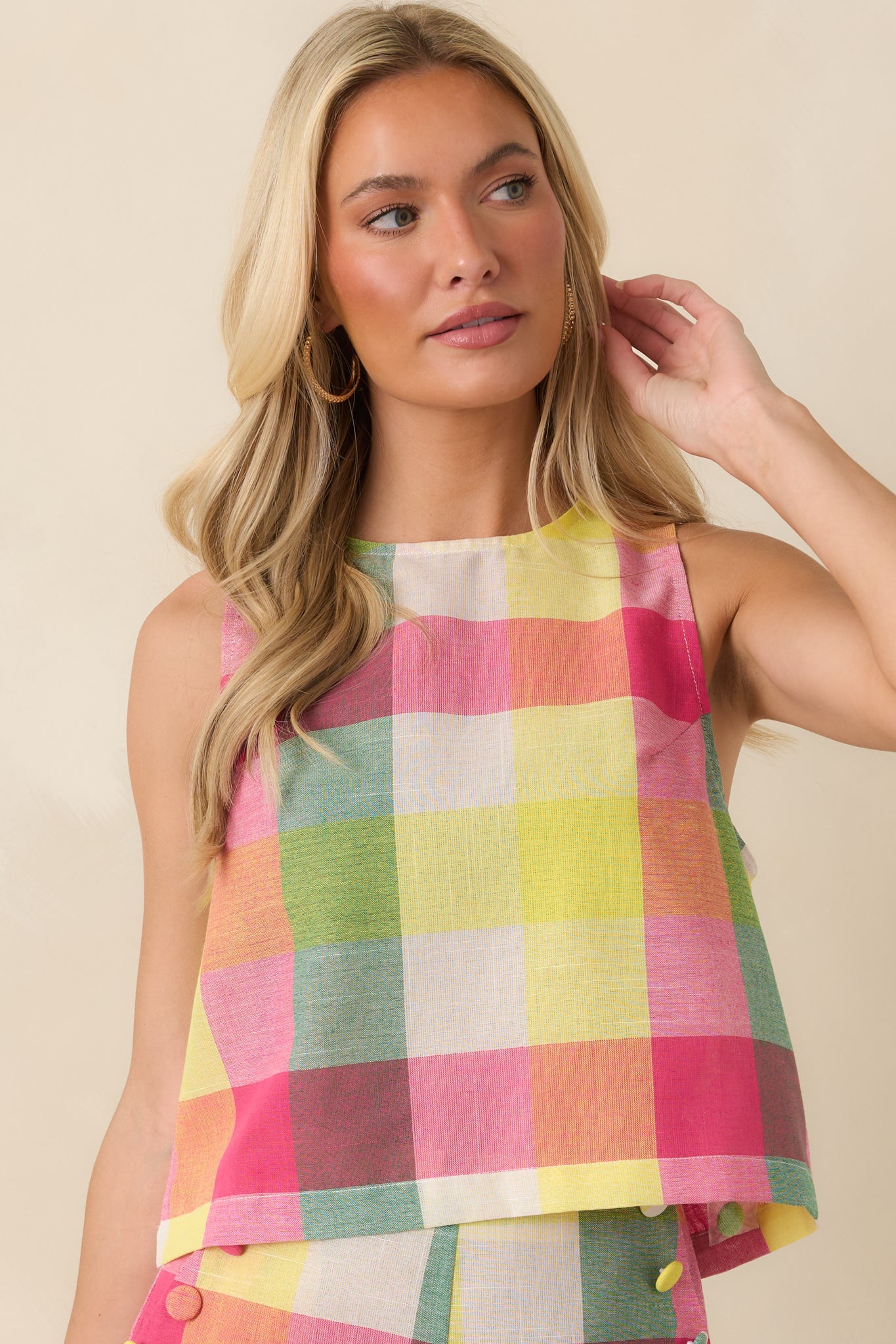 Cropped view of the pink multi plaid sleeveless top emphasizing the round neckline and soft cotton texture.