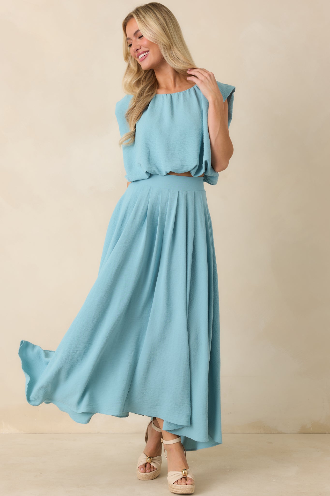 Full-length turquoise skirt with a relaxed drape, elastic waistband, and elegant sweeping shape.