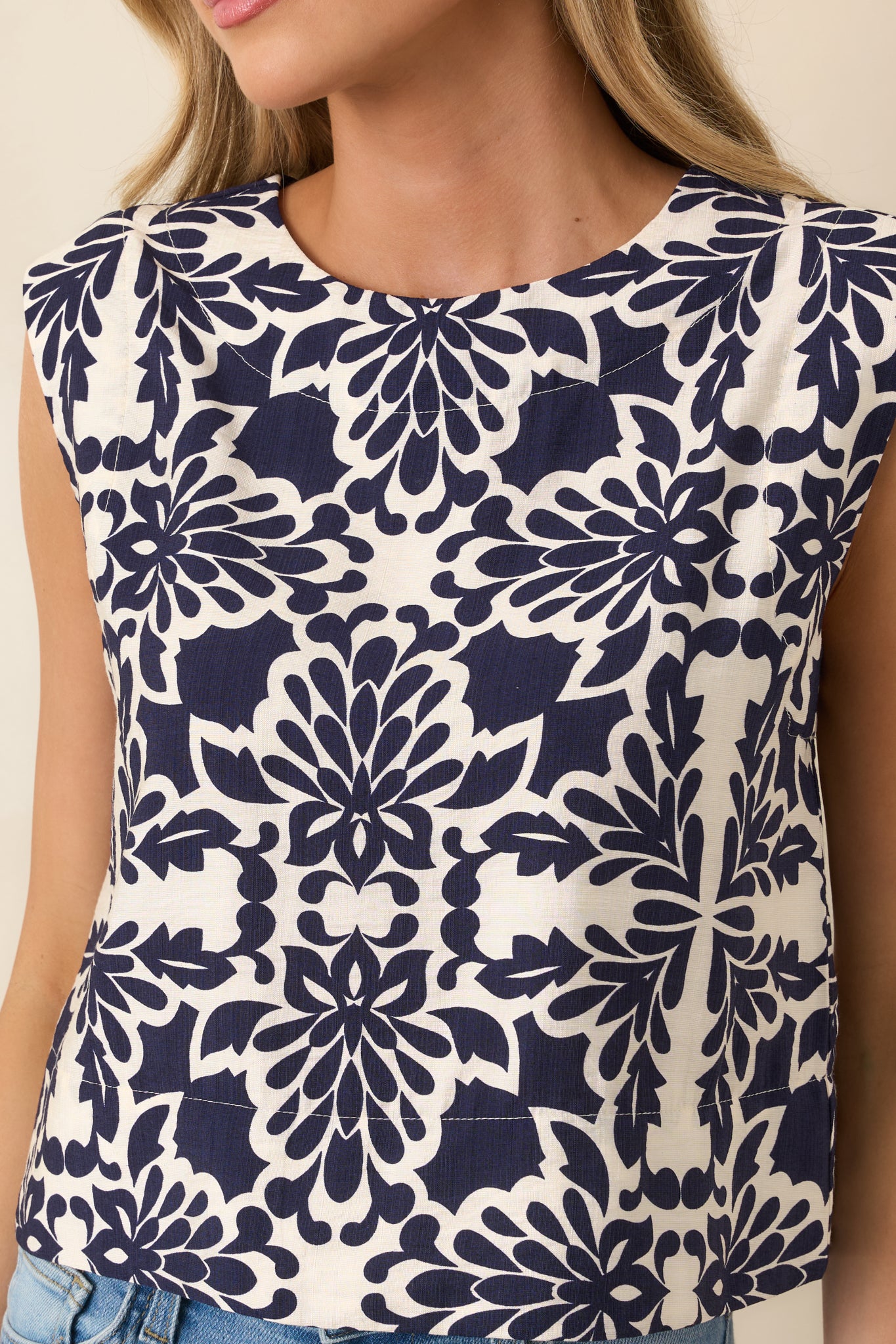Close-up of top featuring Sicilian tile-inspired print, round neckline, and textured fabric