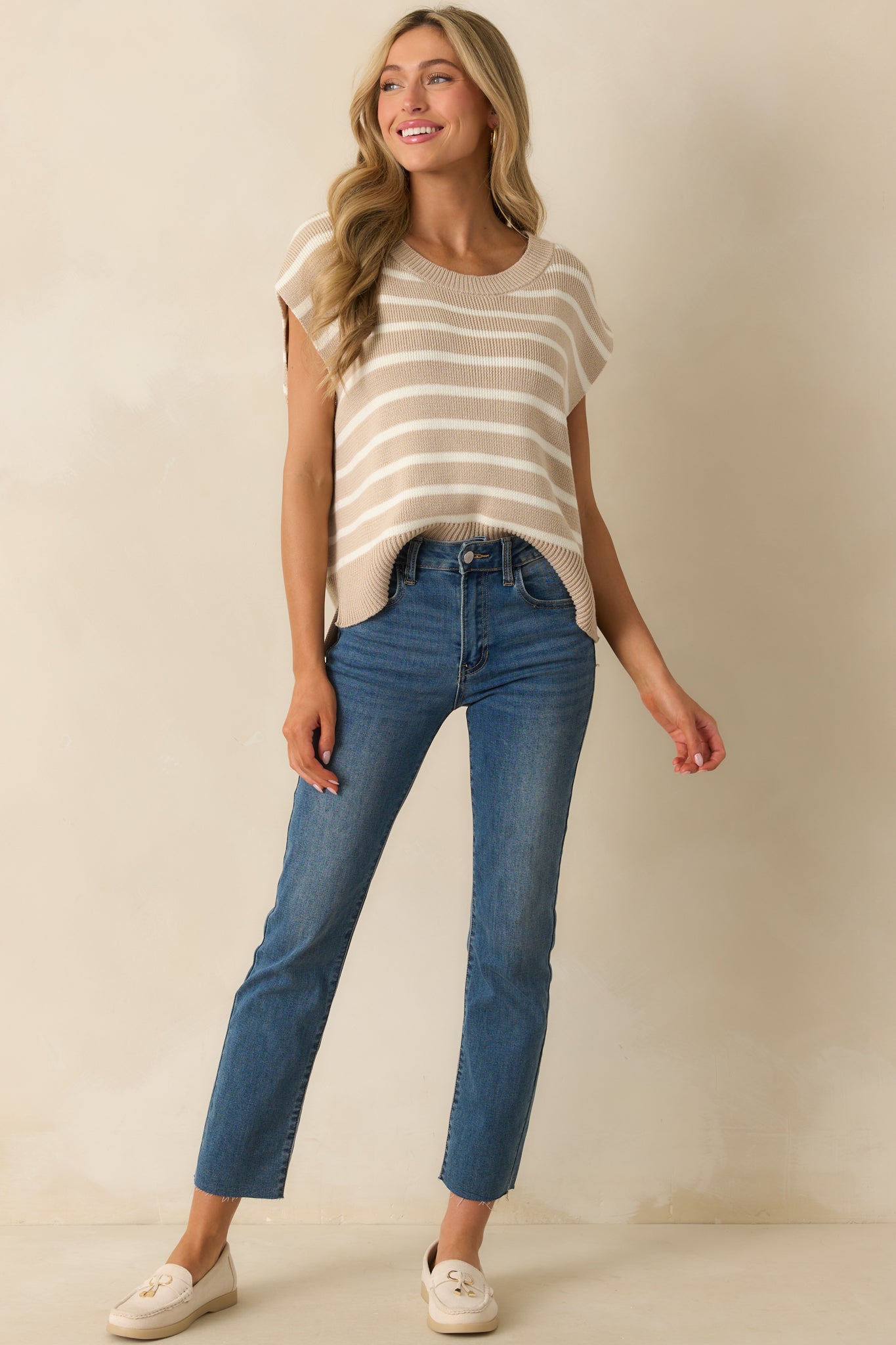 Front view of the vest featuring soft taupe fabric, oversized design, and casual horizontal stripe pattern.