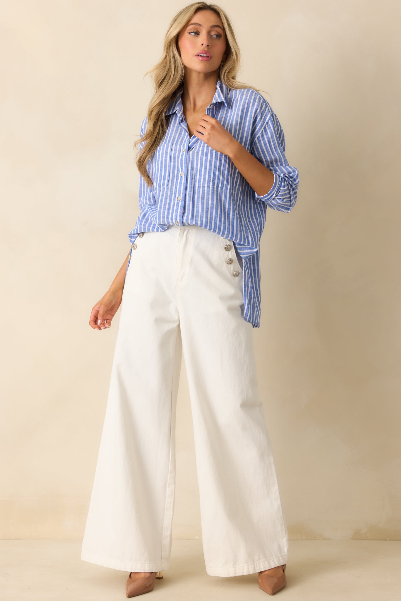 Long-sleeve blue stripe shirt with functional front pockets and crisp button closure.