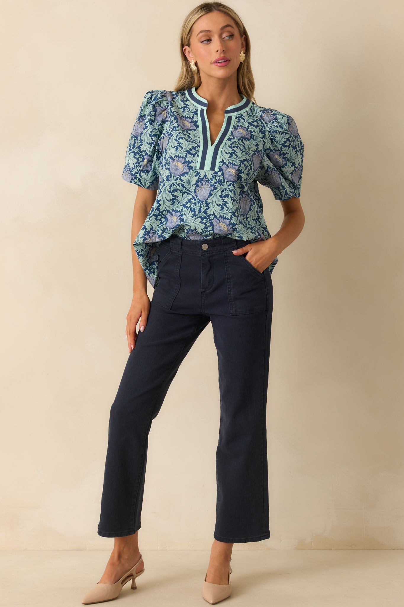 A front view of the navy jeans with a high waisted design, large front pockets, and straight leg cut.