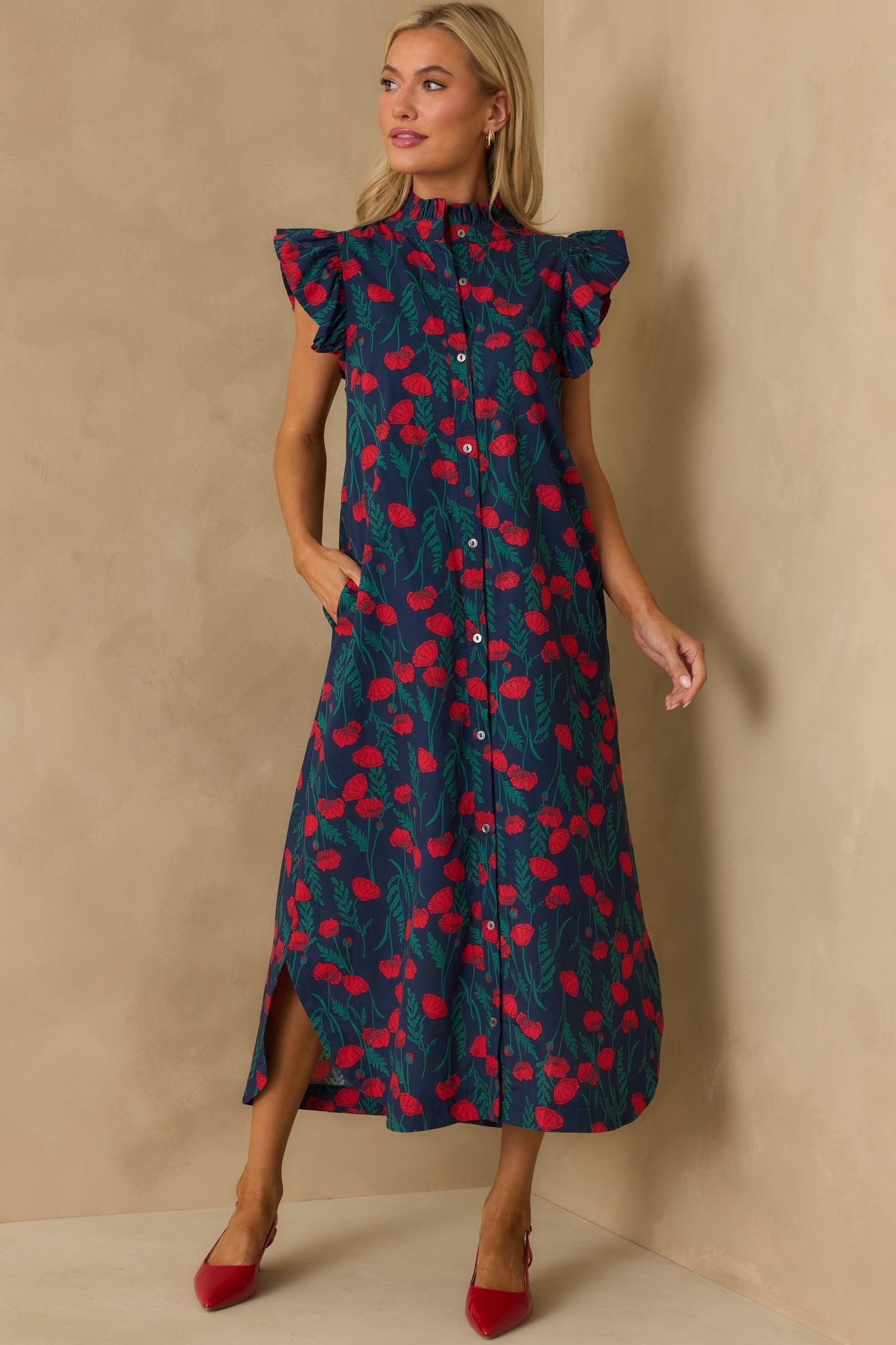 Full-length navy dress with pockets and a button-front closure.