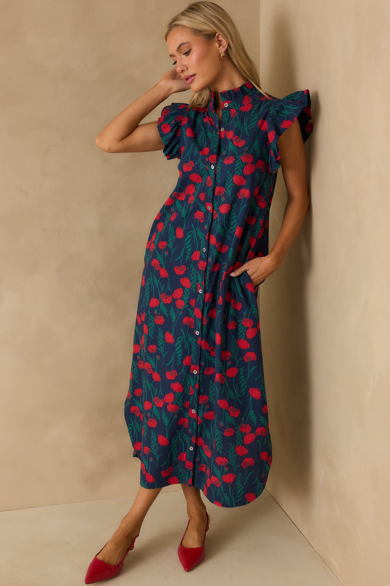 Navy floral maxi dress with red and green print, finished with flutter sleeves.
