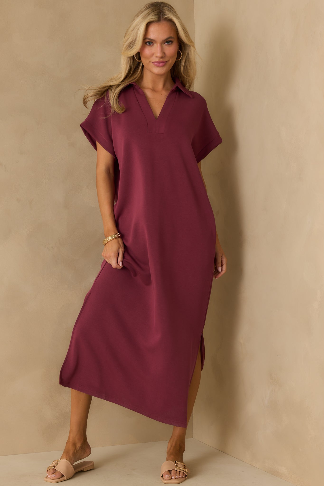 Buttery soft burgundy midi dress designed with short sleeves and a relaxed shape.