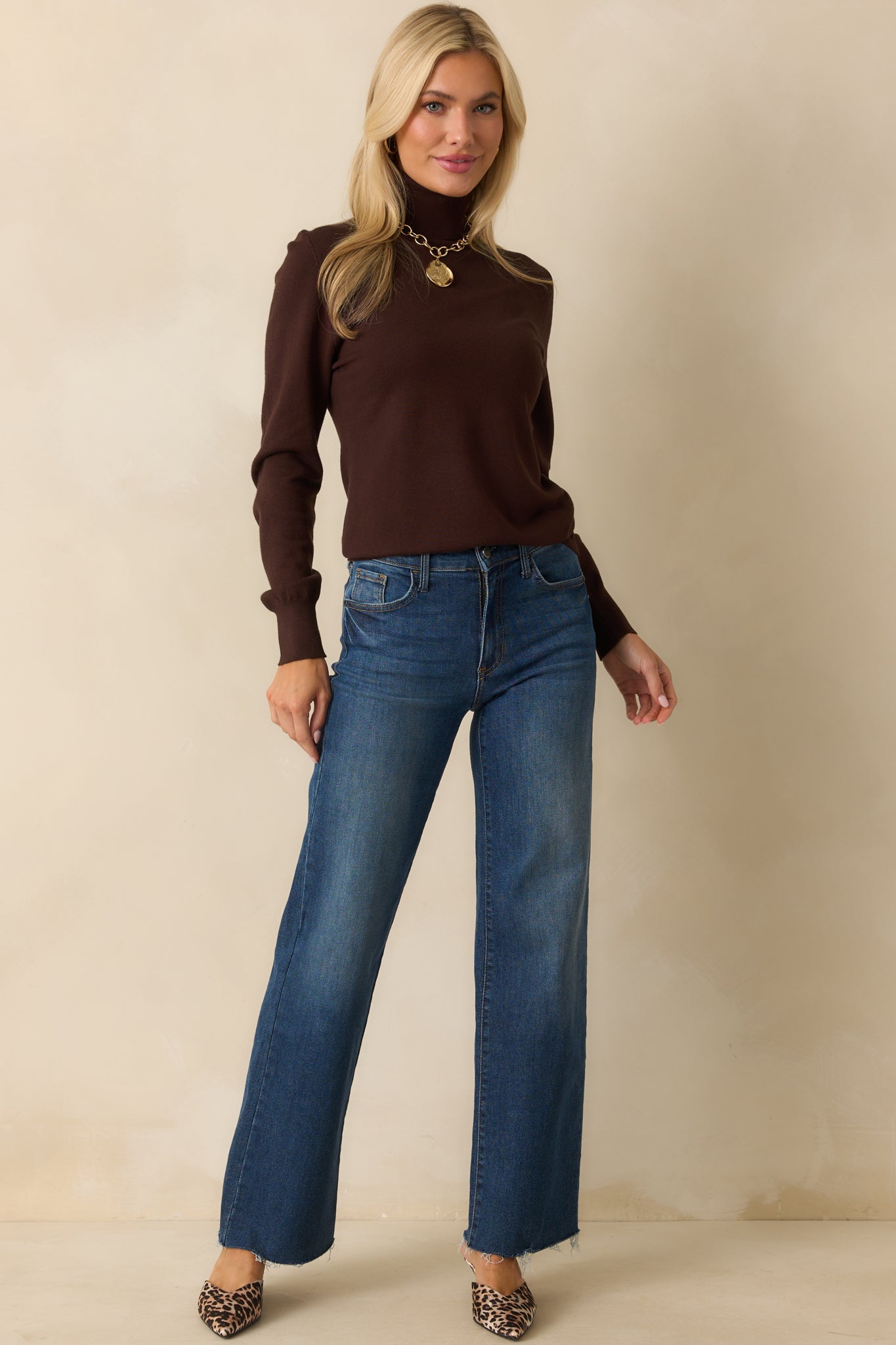 Another full-length shot of the brown sweater displaying the ribbed sleeve cuffs and comfortable fit.