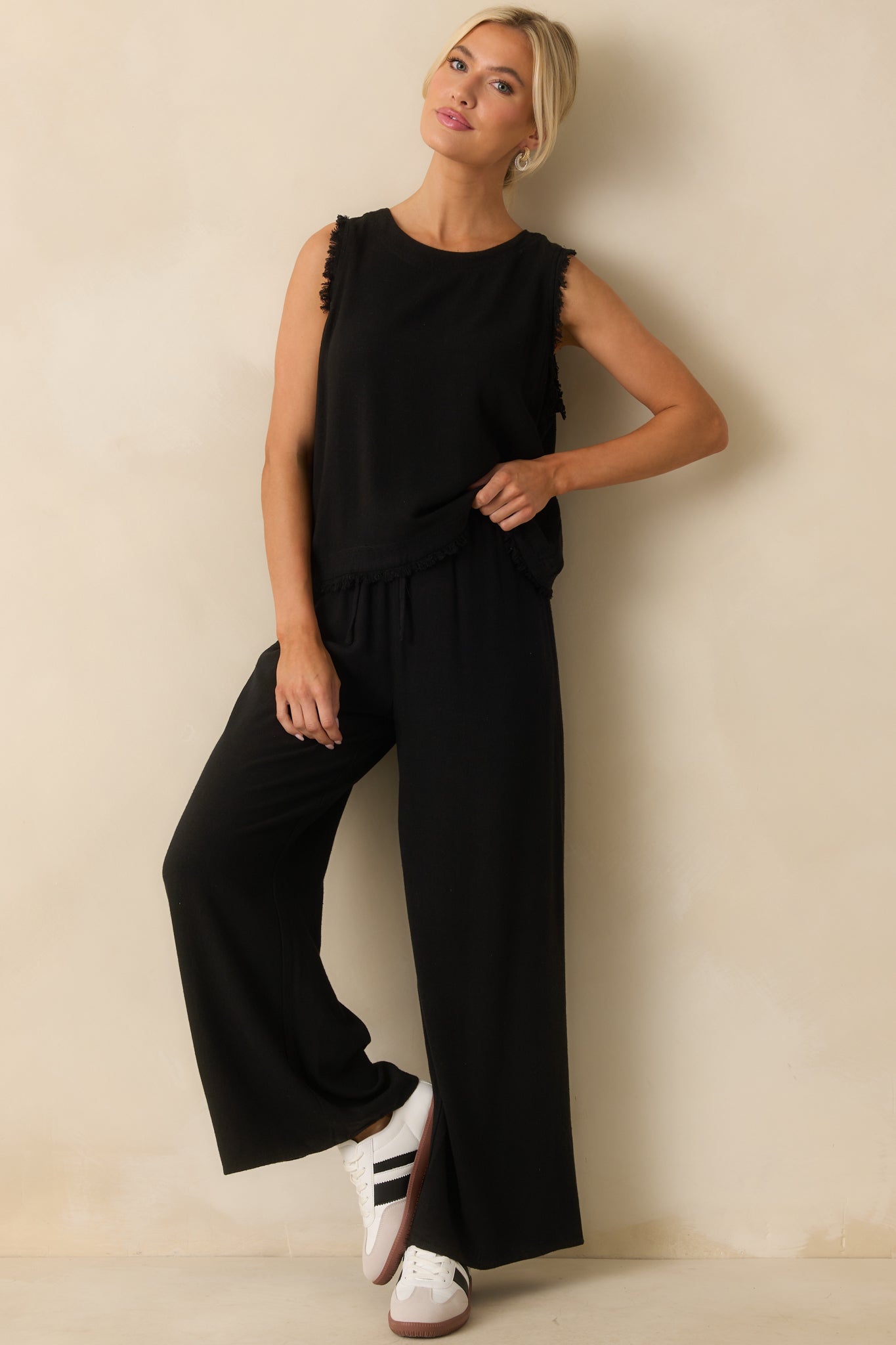 Full front view of the black pants showing the high waisted design, wide leg silhouette, and relaxed fit.