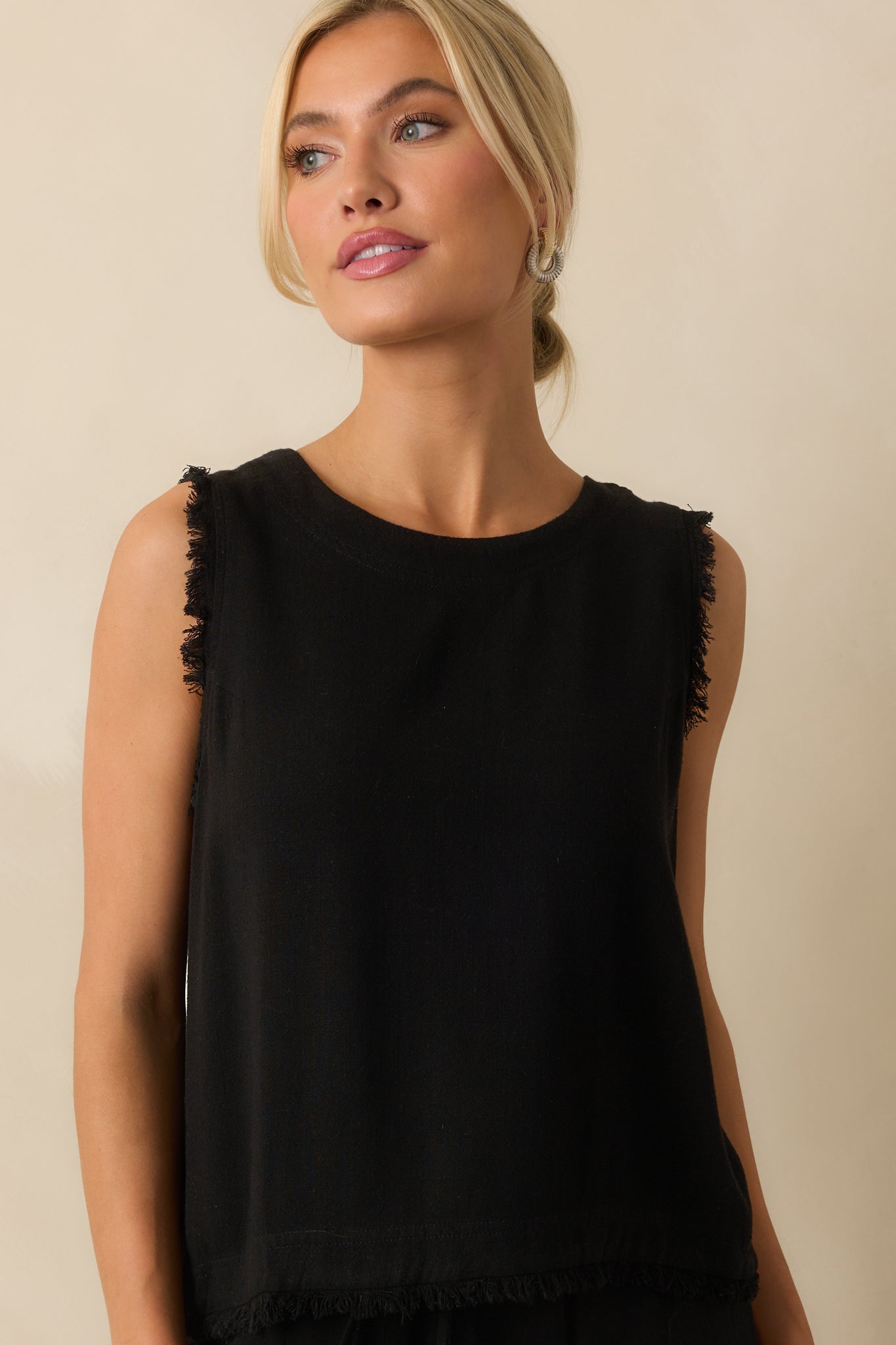 Front close-up showing fabric texture, frayed shoulders, and hemline detail.