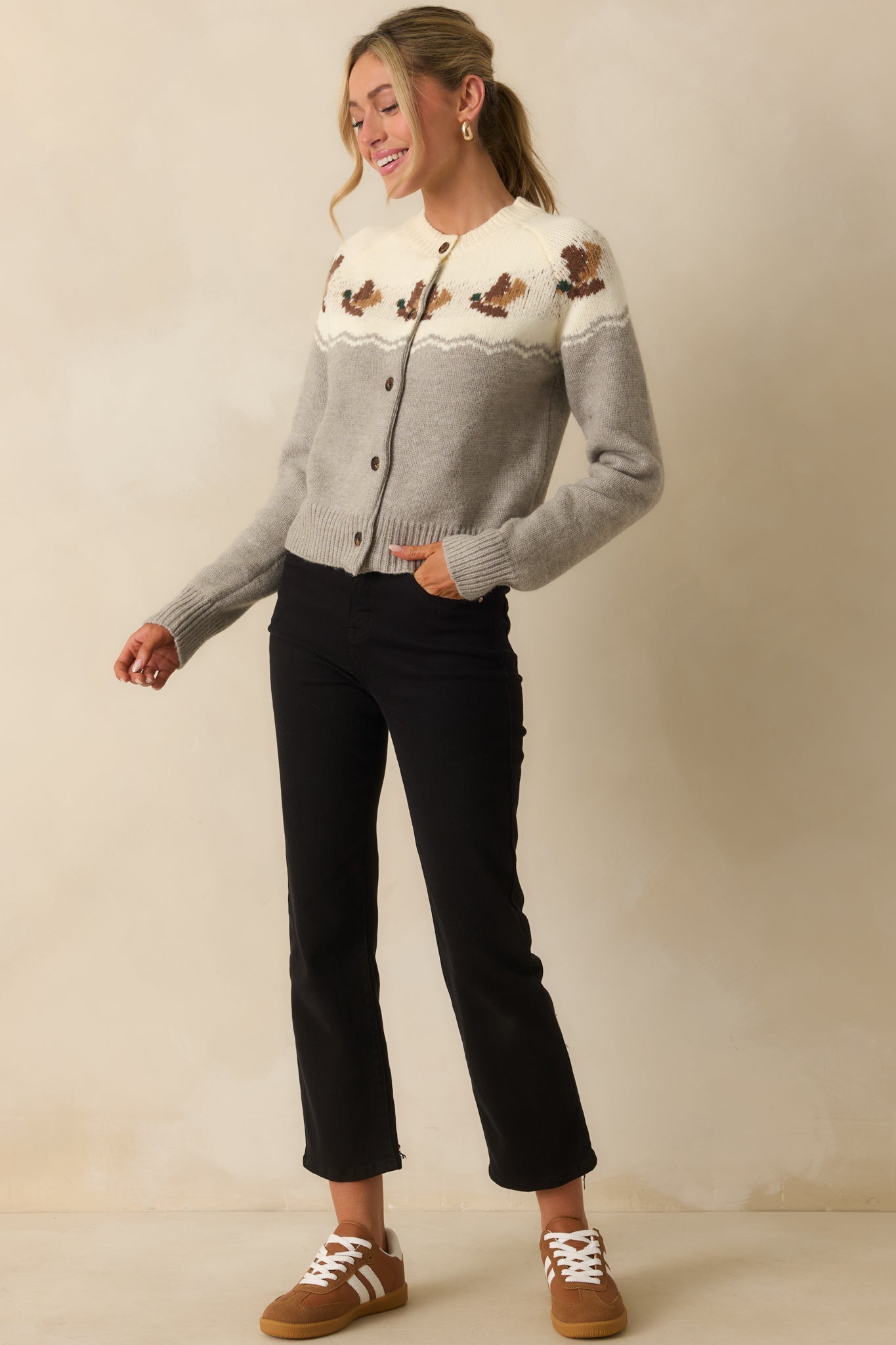 Cardigan with ribbed hems and contrasting grey and ivory knit pattern.