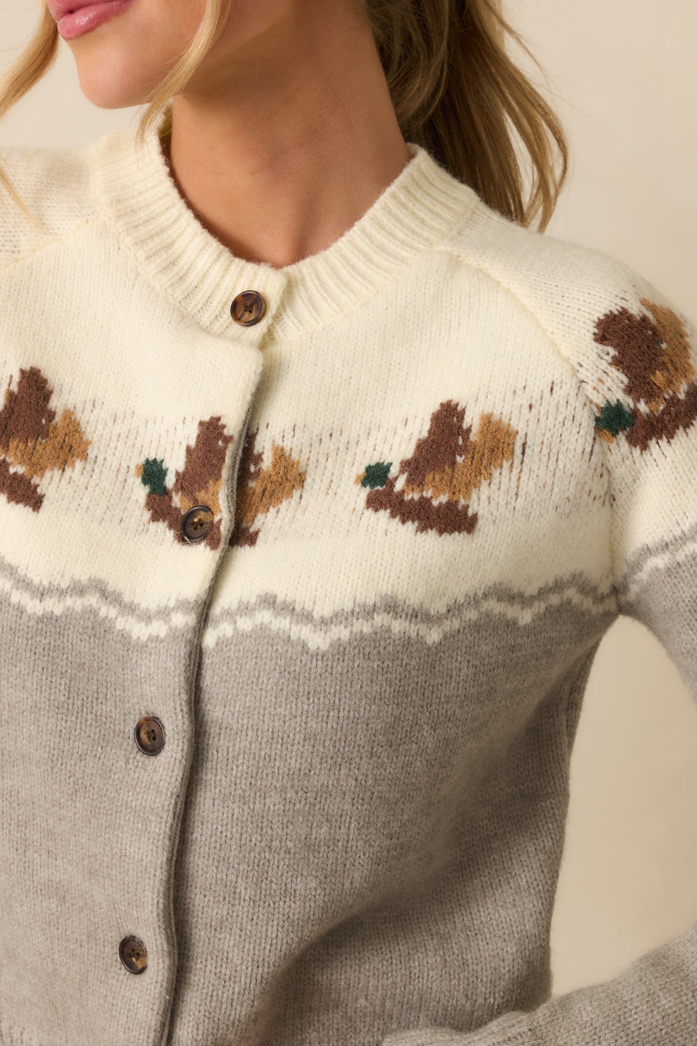 Detailed view of the intarsia duck motif and ribbed knit texture.