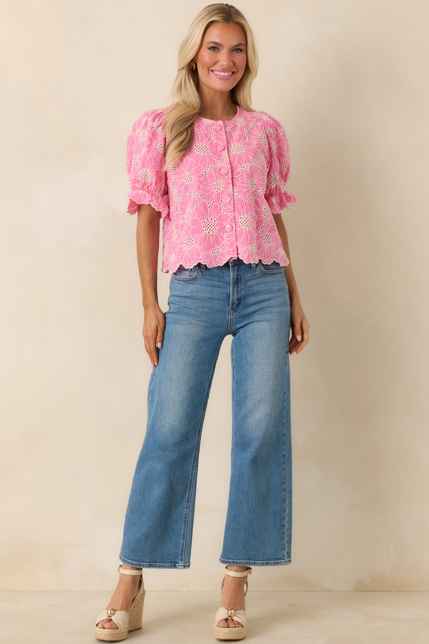 Romantic floral top with textured eyelet fabric and playful puff sleeves.