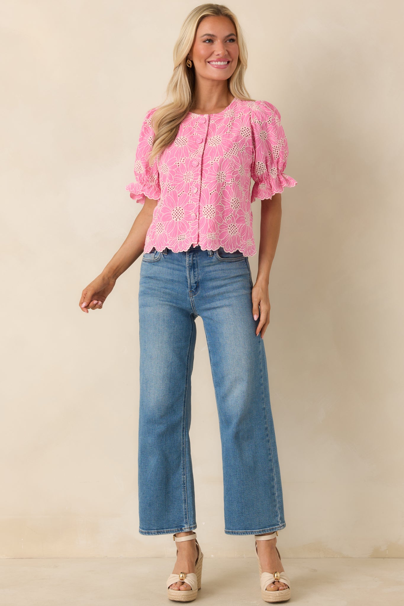 Detailed embroidered top with scalloped hem and polished button-front design.