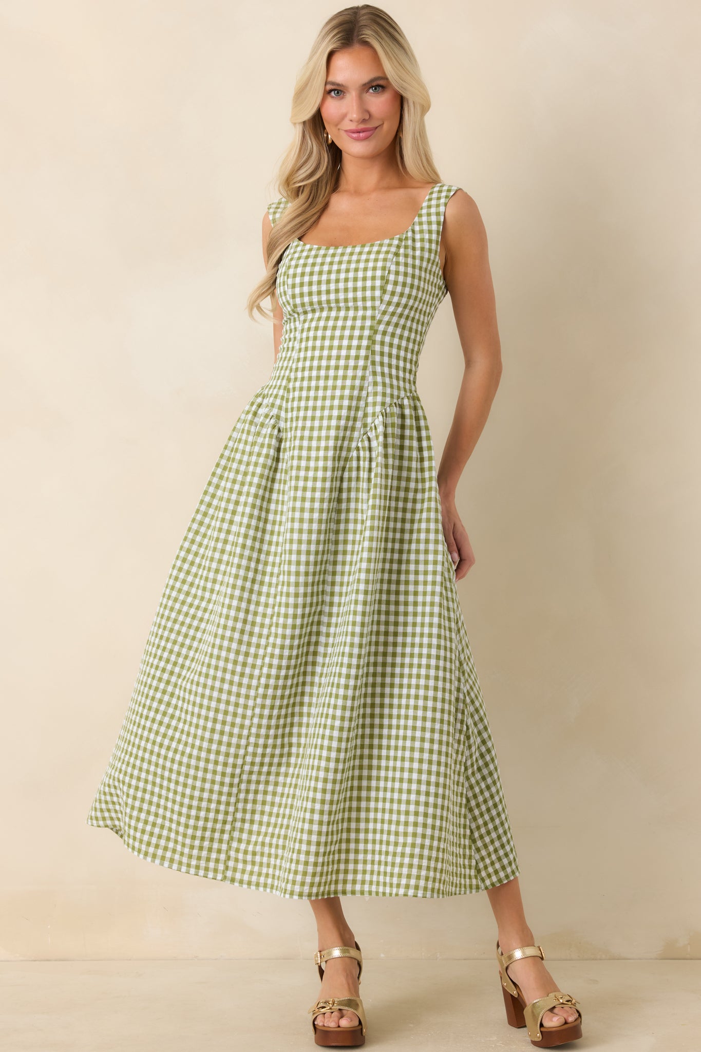 Green gingham midi dress with subtle waist shaping, crisp check pattern, and an easy, polished drape.