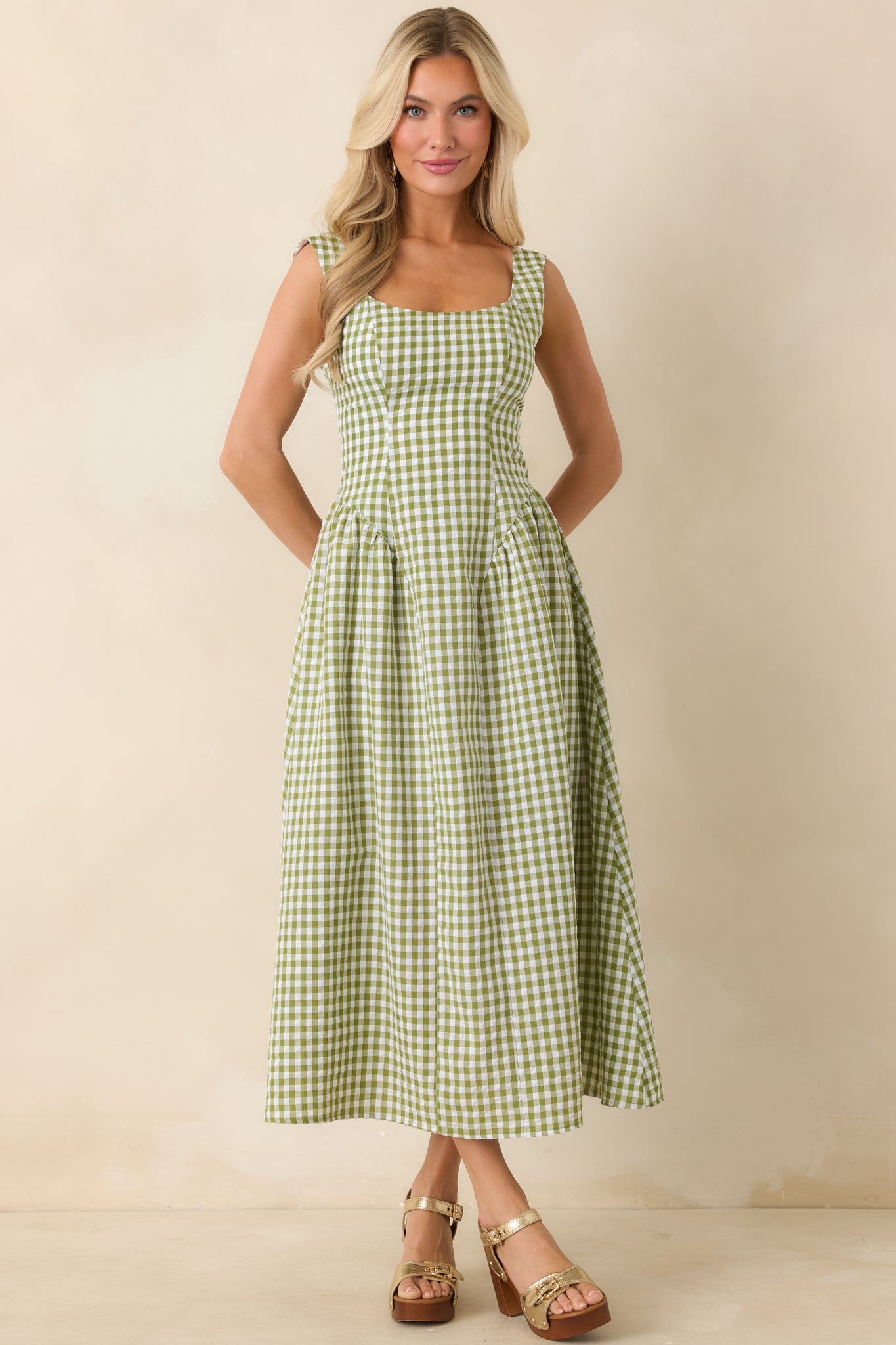 Green and white check midi dress featuring a structured cotton-blend feel, defined waist, and a softly flared silhouette.