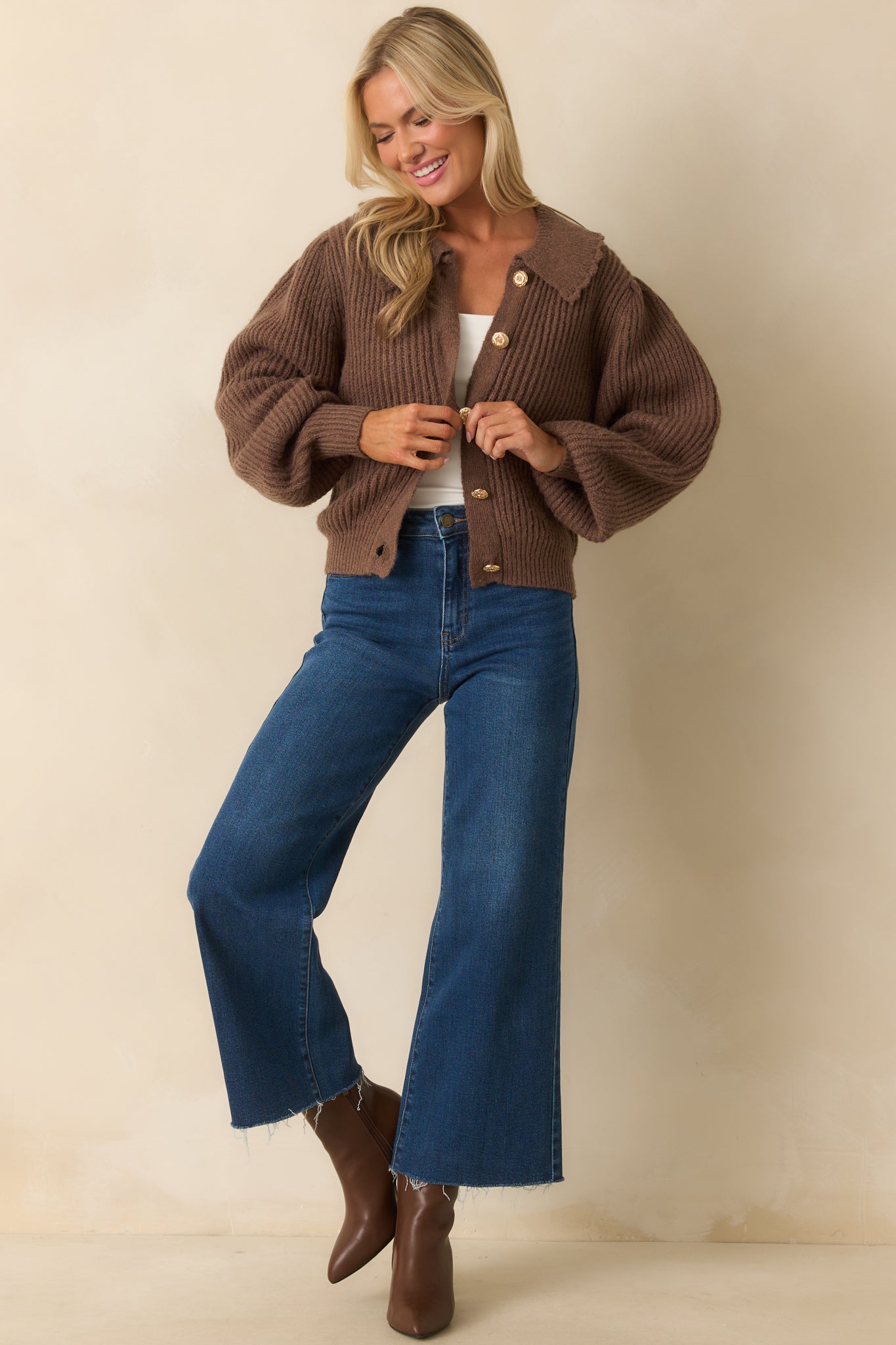 Brown ribbed knit cardigan with peter pan collar featuring scalloped edges, long balloon sleeves, and slightly cropped length.
