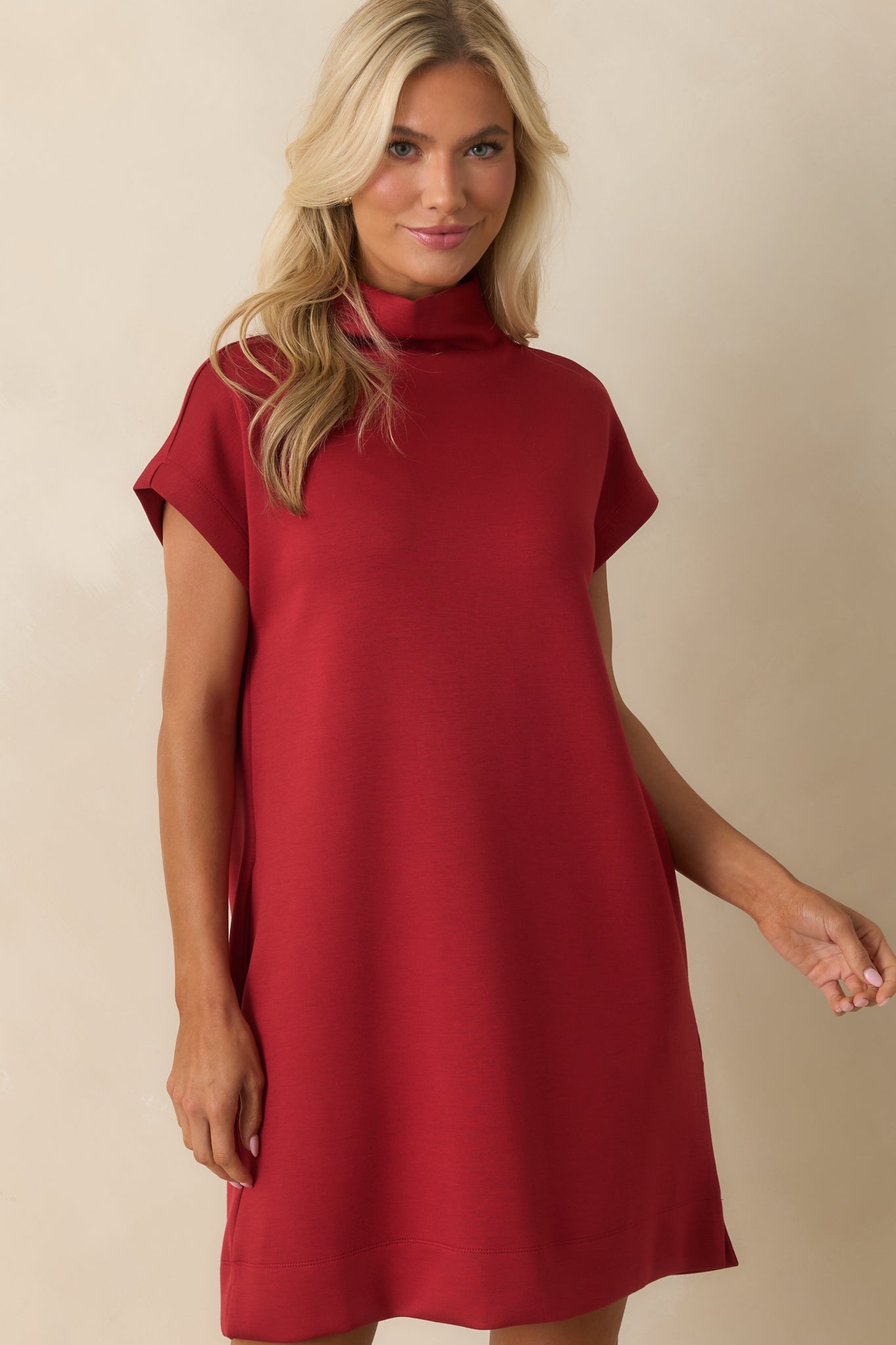 Shift silhouette red dress highlighting side vent slit accents.