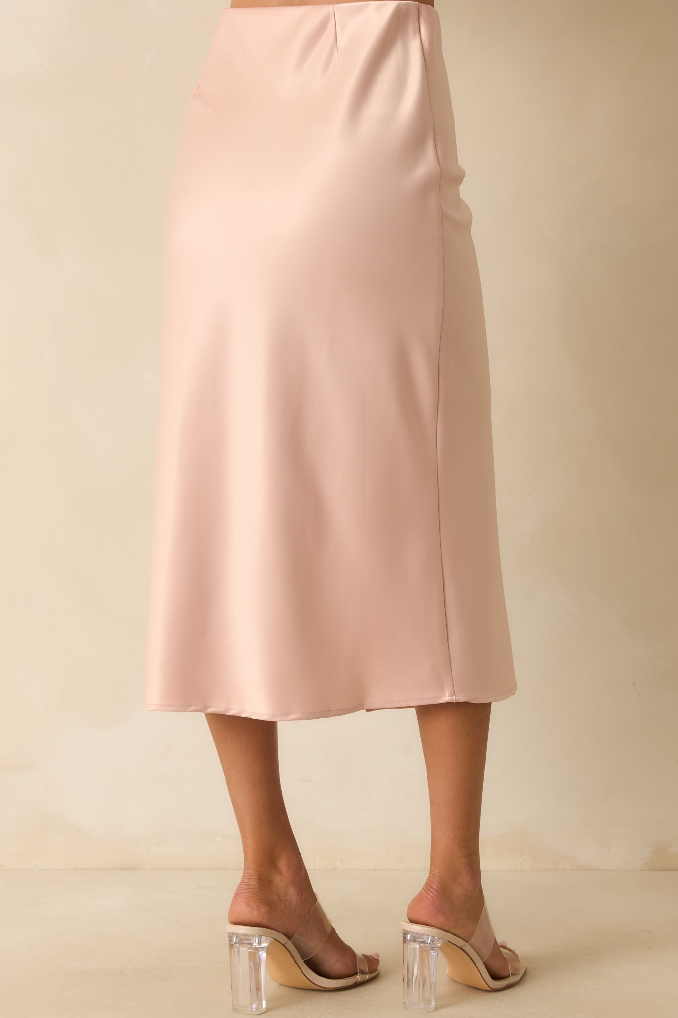 A back view of the skirt featuring an elastic waistband and smooth satin finish.