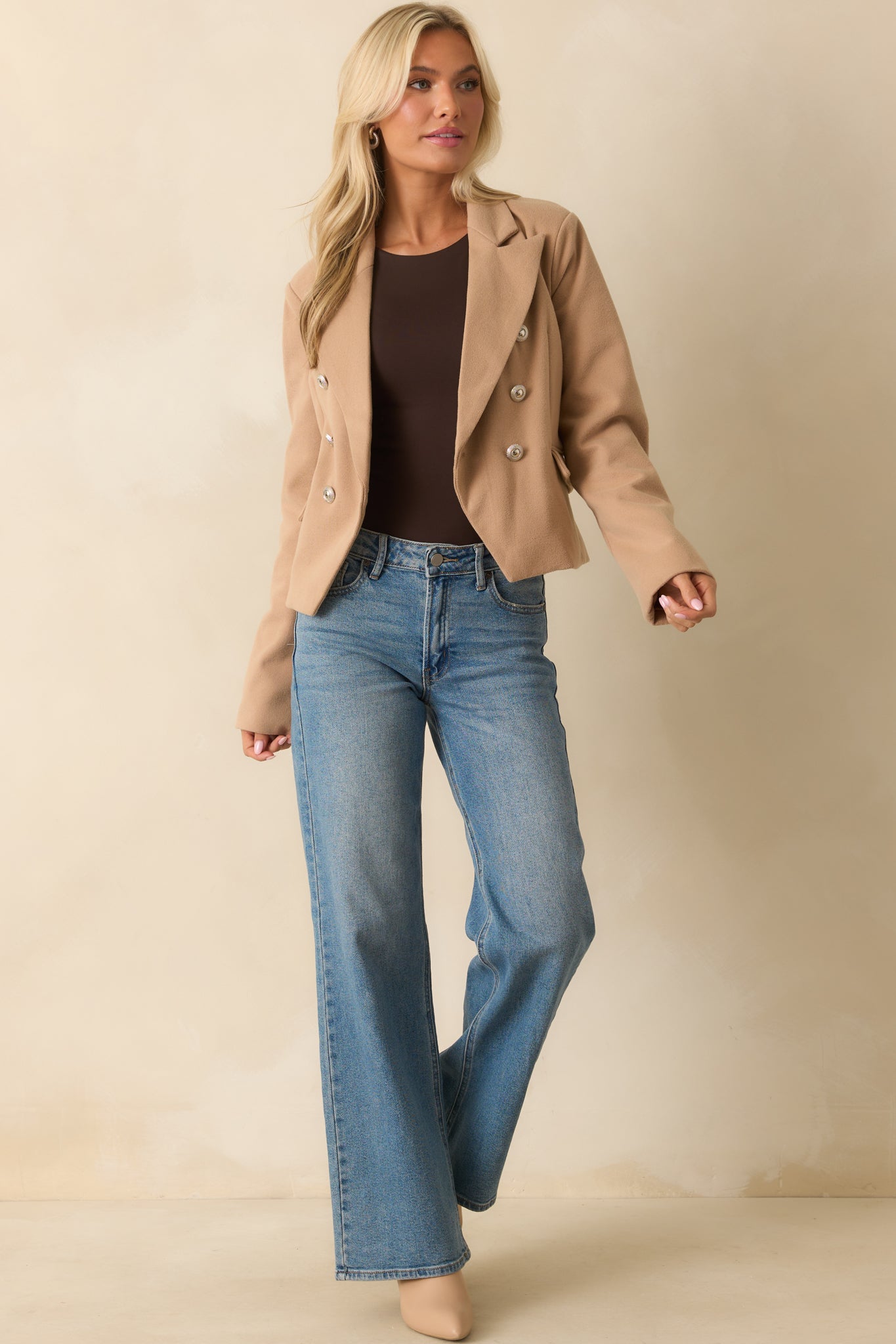 A front view of the tan blazer with a lapel collar, cropped boxy fit, and functional button front featuring silver embellished buttons.