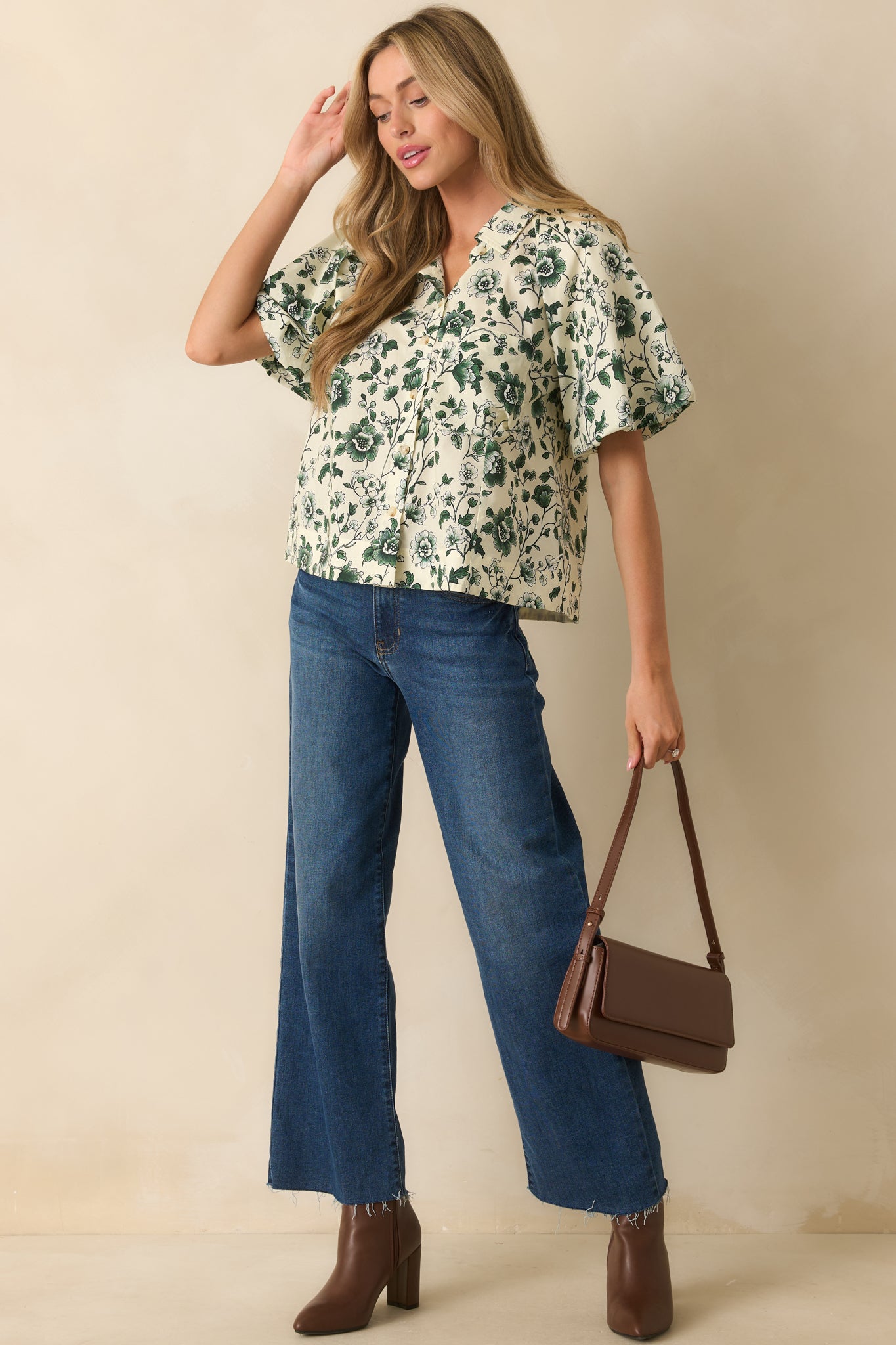 Button-front green floral top highlighting the relaxed fit and elastic cuffs.