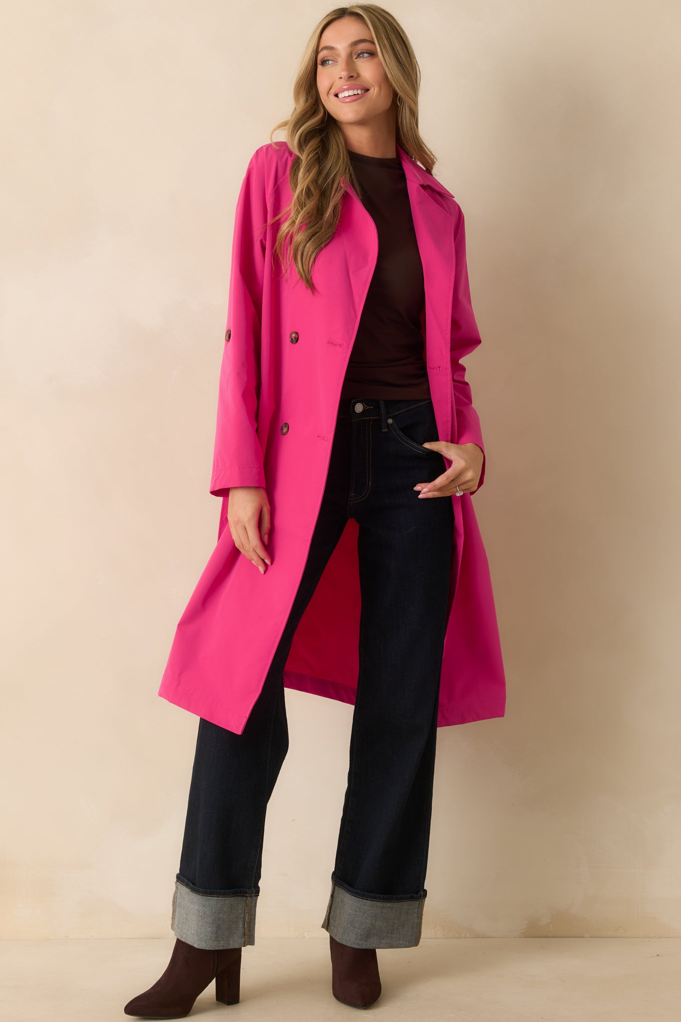 Front view of the coat highlighting the functional button closure, pockets, and relaxed fit.