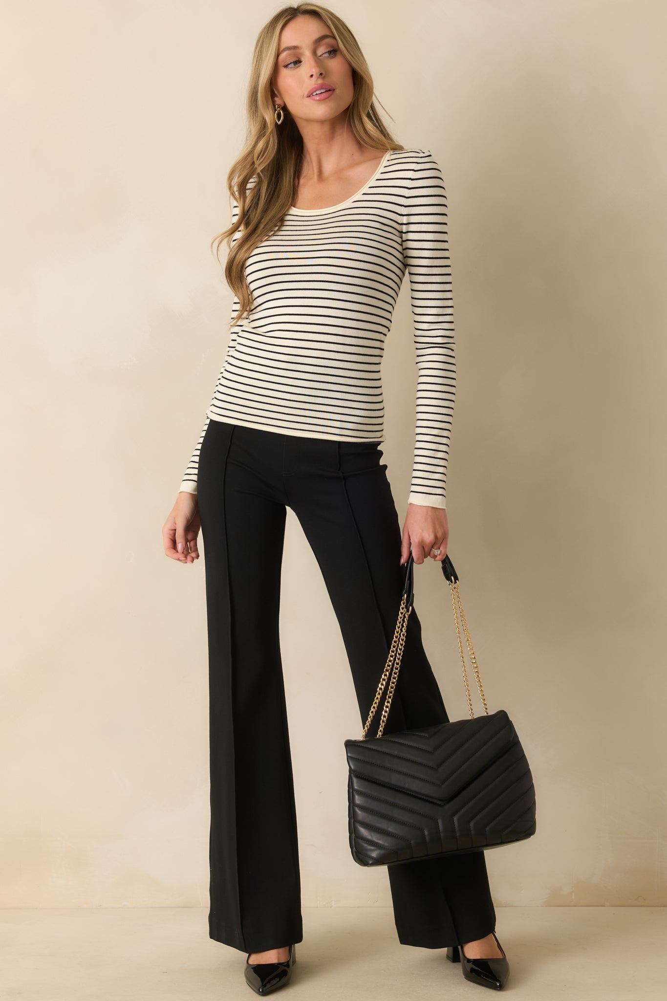 Ivory and black striped top with long sleeves and soft, comfortable fabric.