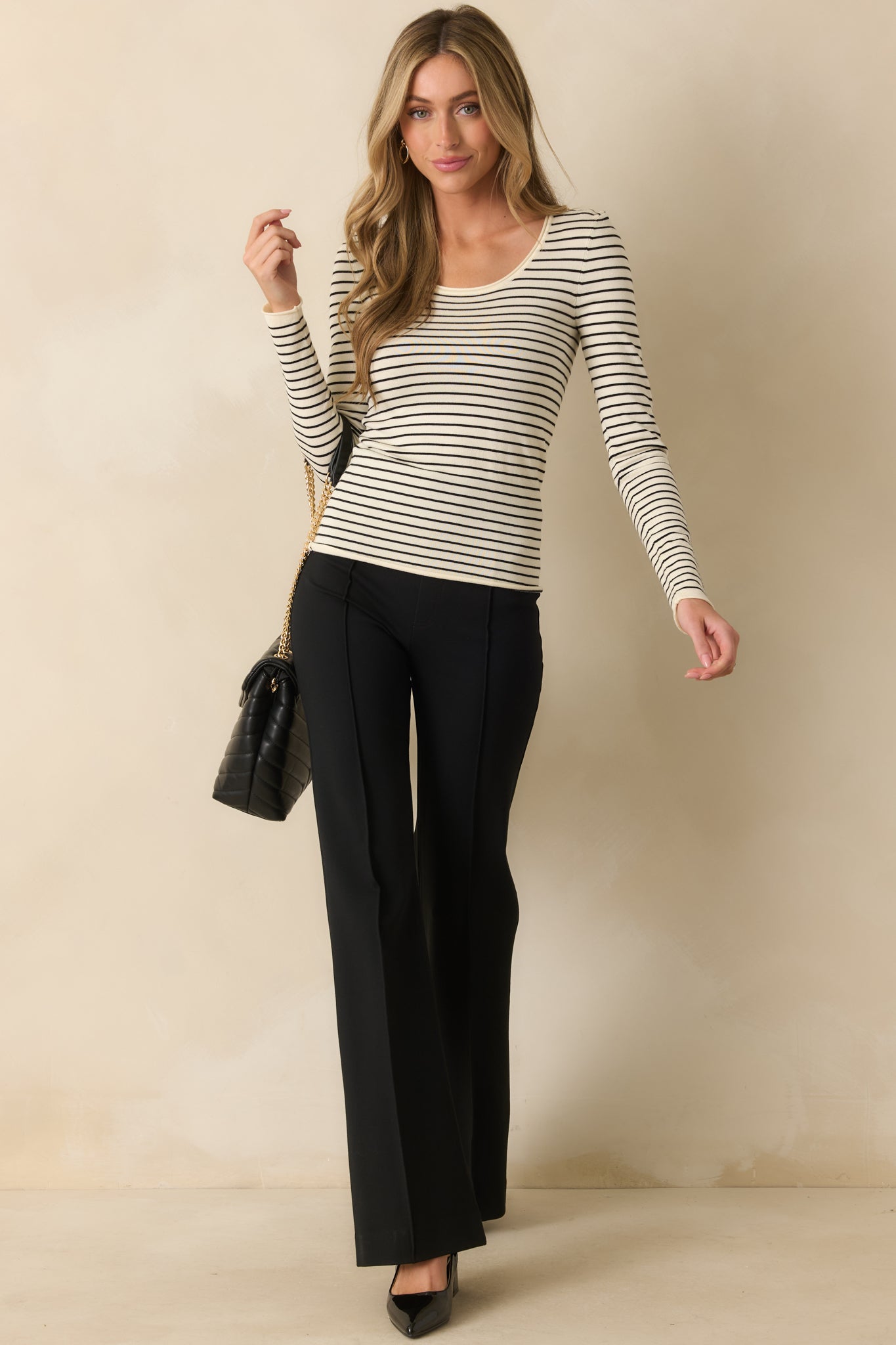 Full-length front view of ivory top showing a casual, striped design and relaxed fit.