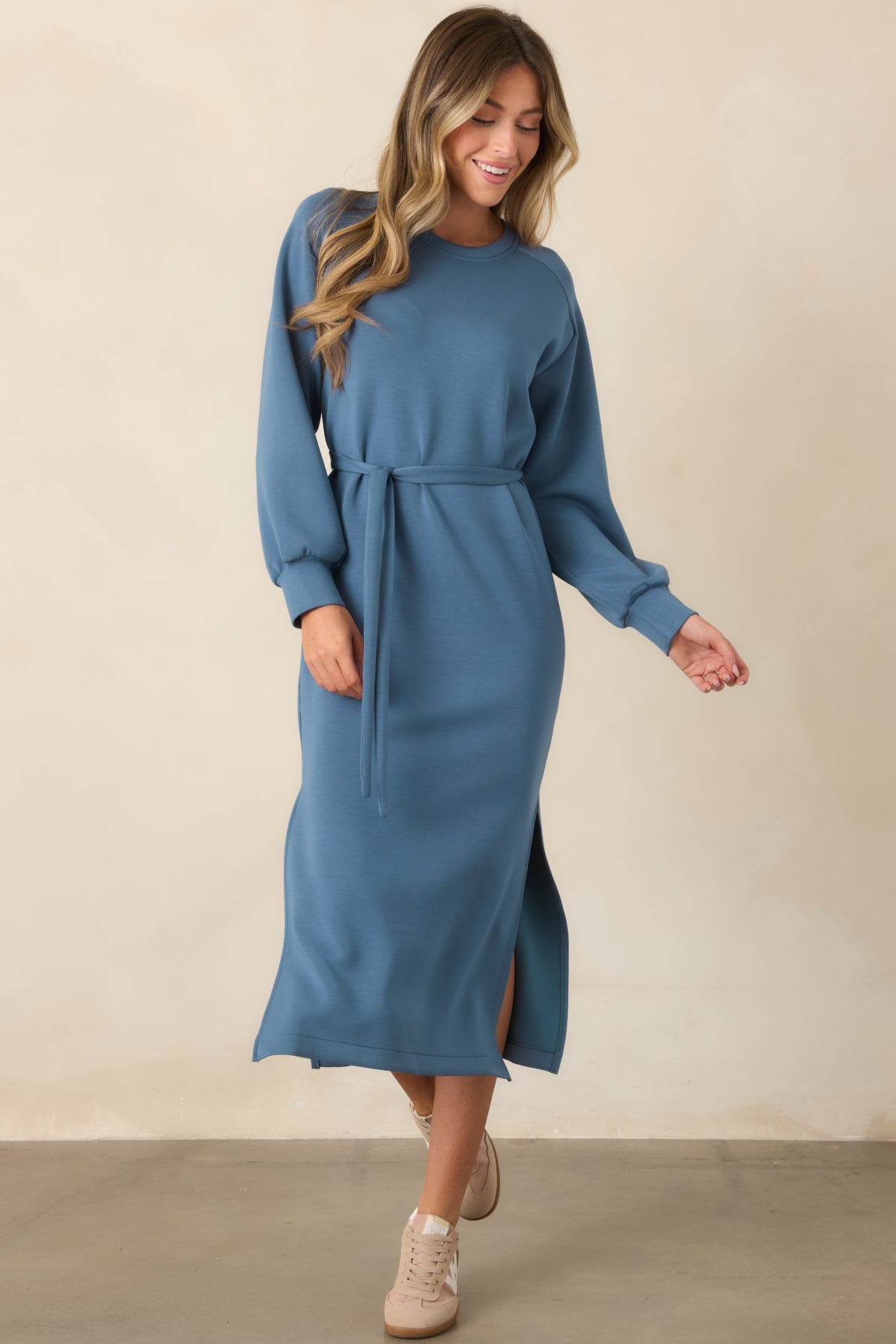Blue long sleeve midi dress with a simple crew neckline and softly defined waist