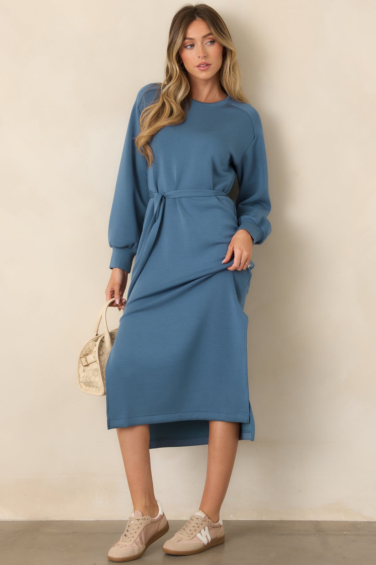 Blue midi dress with long sleeves, fitted cuffs, and a straight skirt
