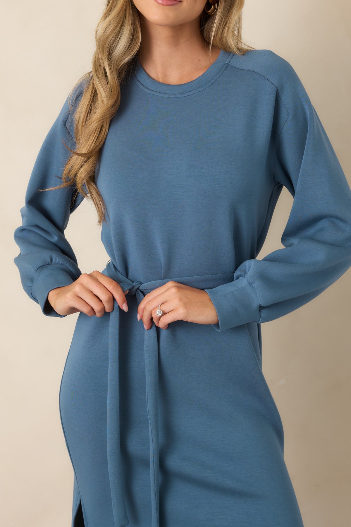 Close up of the self-tie belt on a soft blue midi dress