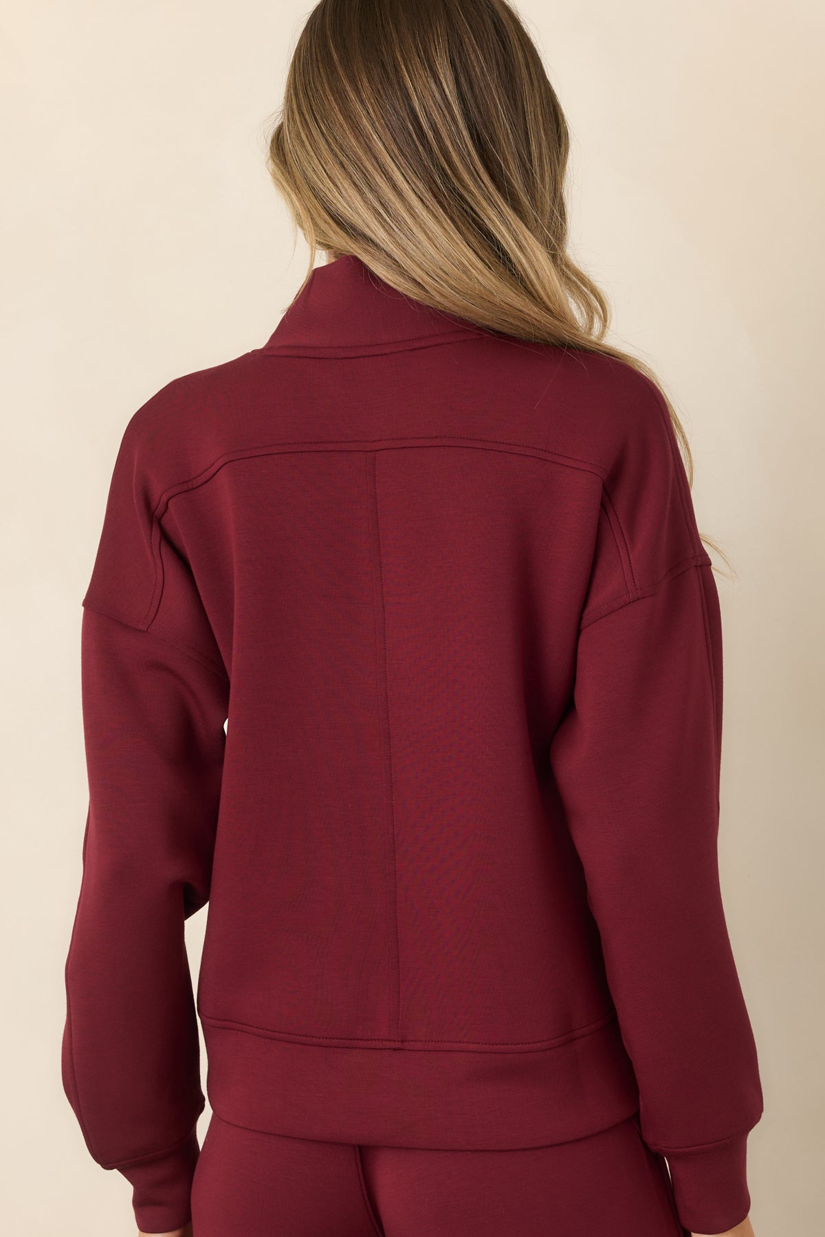 Back view of vino red sweatshirt with dropped shoulders, center seam, and banded hem