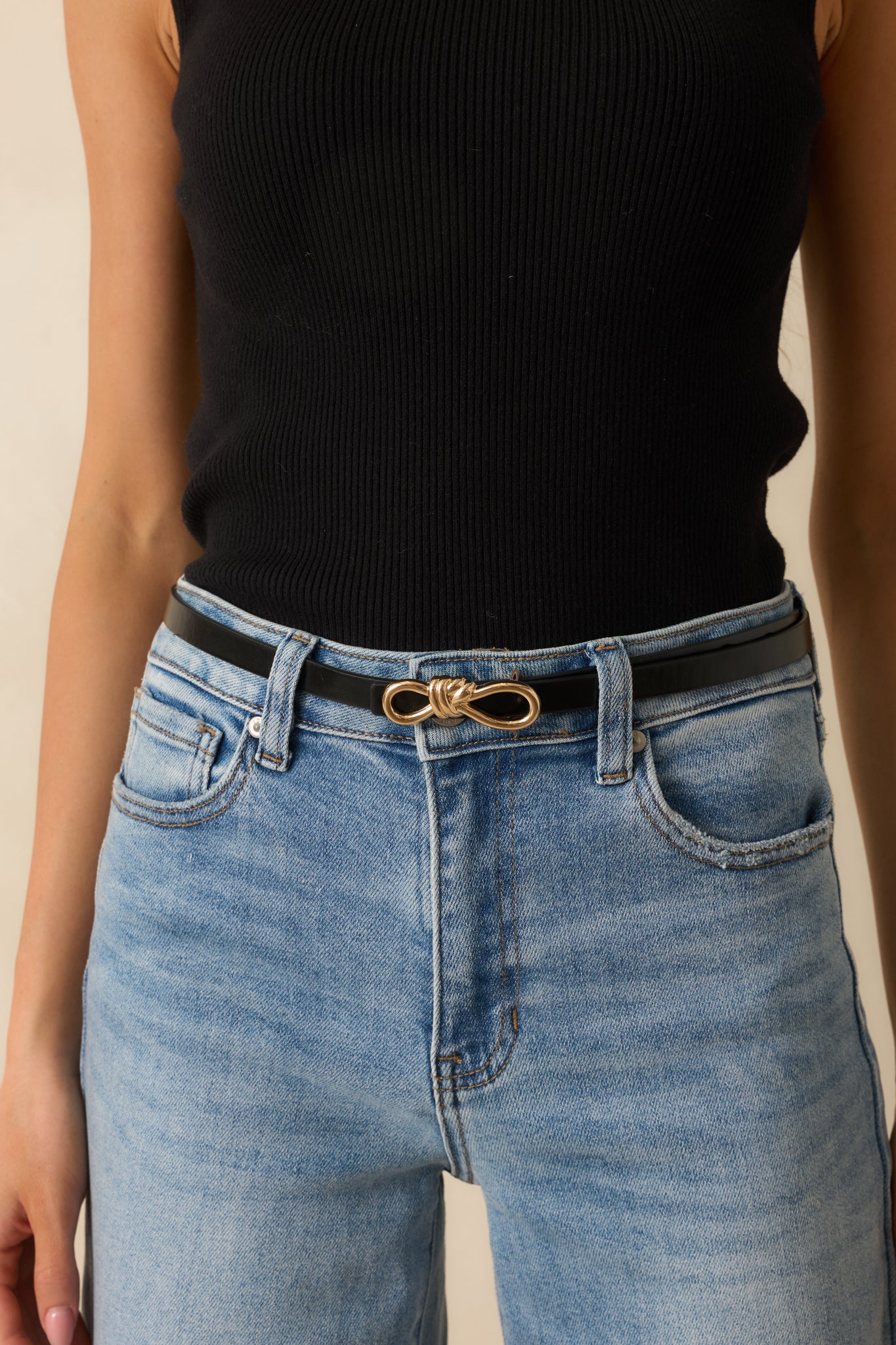Another cropped view showcasing the black belt at the waist, highlighting its gold interlocking buckle.